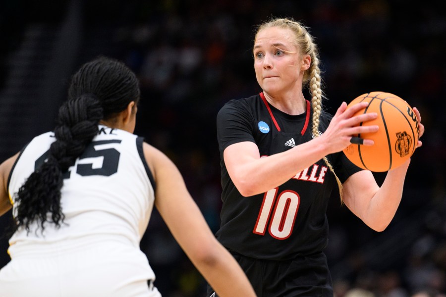 Louisville guard Hailey Van Lith (10) looks for a pass as Iowa forward Hannah Stuelke defends in the second half of an Elite 8 college basketball game of the NCAA Tournament, Sunday, March 26, 2023, in Seattle. (AP Photo/Caean Couto)