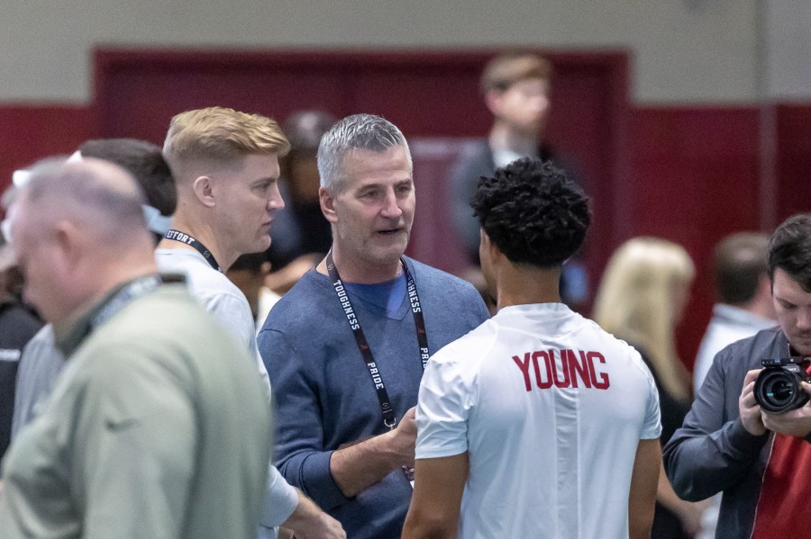 FILE - Carolina Panthers head football coach Frank Reich talks with former Alabama quarterback Bryce Young at Alabama's NFL pro day, Thursday, March 23, 2023, in Tuscaloosa, Ala. The Panthers packaged two first-round picks, two second-round picks and star receiver D.J. Moore to move up from No. 9 in the draft to the top pick to give Carolina the pick of the lot at quarterback in next week's draft. (AP Photo/Vasha Hunt, File)