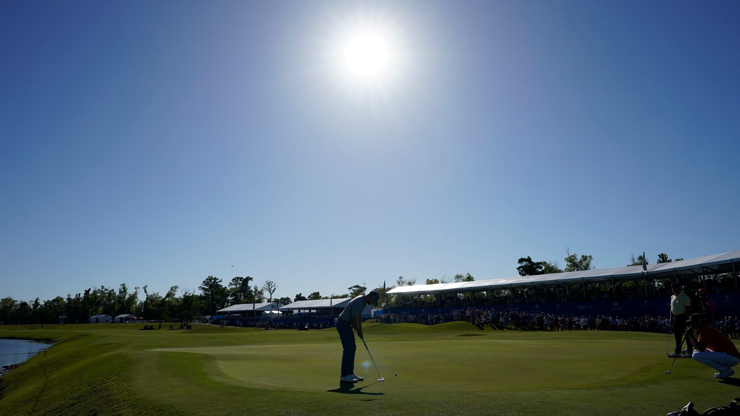 Wyndham Clark makes a birdie putt on the 18th green to take the lead at the end of the third round of the PGA Zurich Classic golf tournament at TPC Louisiana in Avondale, La., Saturday, April 22, 2023. (AP Photo/Gerald Herbert)