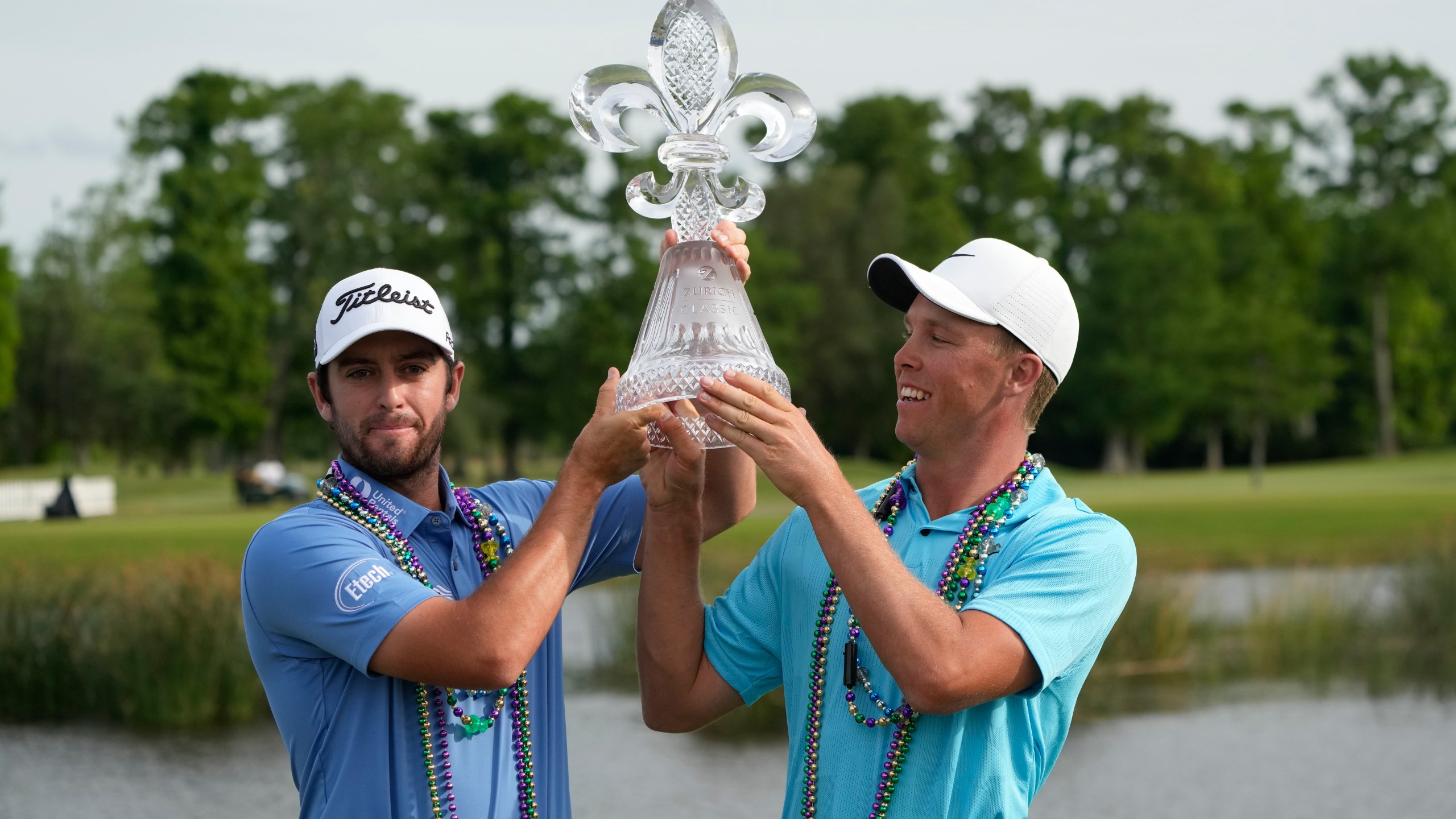 Davis Riley, left, and teammate Nick Hardy hoist their trophy after winning the PGA Zurich Classic golf tournament at TPC Louisiana in Avondale, La., Sunday, April 23, 2023. (AP Photo/Gerald Herbert)