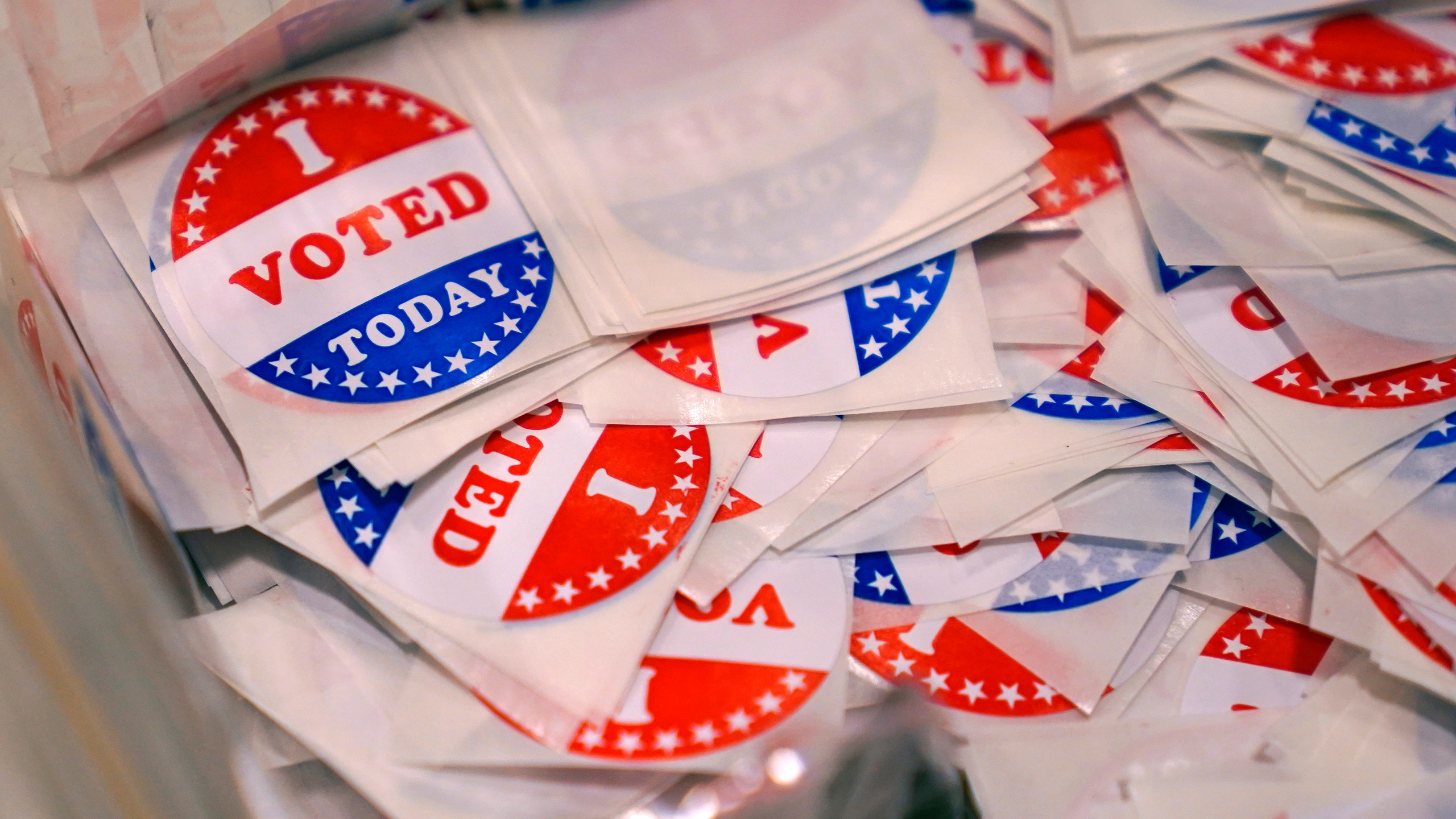 FILE - A bin of "I Voted Today" stickers rests on a table at a polling place, Sept. 13, 2022, in Stratham, N.H. A New Hampshire man who posted a fake Craigslist ad for a free trailer with a legislative candidate’s number on the day of the election has lost his right to vote in the state. Michael Drouin, 30, pleaded guilty Monday, April 24, 2023, to creating a false document after a flood of unwanted calls and texts jammed up the candidate's cell phone. (AP Photo/Charles Krupa, File)