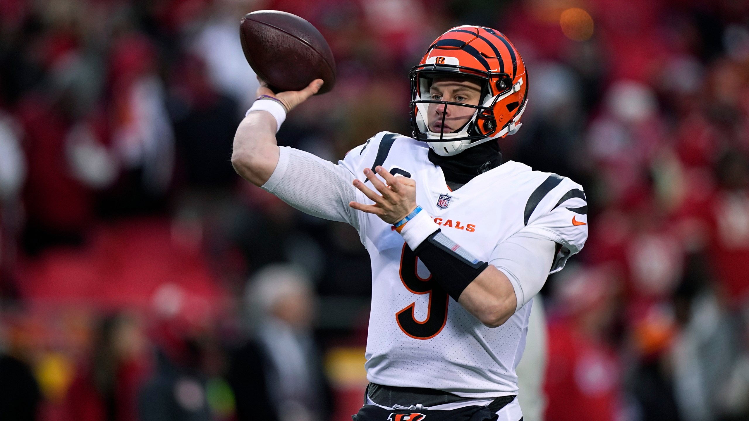 FILE - Cincinnati Bengals quarterback Joe Burrow throws a pass against the Kansas City Chiefs during the first half of the AFC championship NFL football game Jan. 29, 2023, in Kansas City, Mo. The Bengals exercised the fifth-year contract option on Burrow as they move toward signing him to a long-term deal. The Bengals said they made the “mechanical step" Tuesday, April 25, as they work with Burrow and his representatives toward securing him for the future. (AP Photo/Brynn Anderson, File)