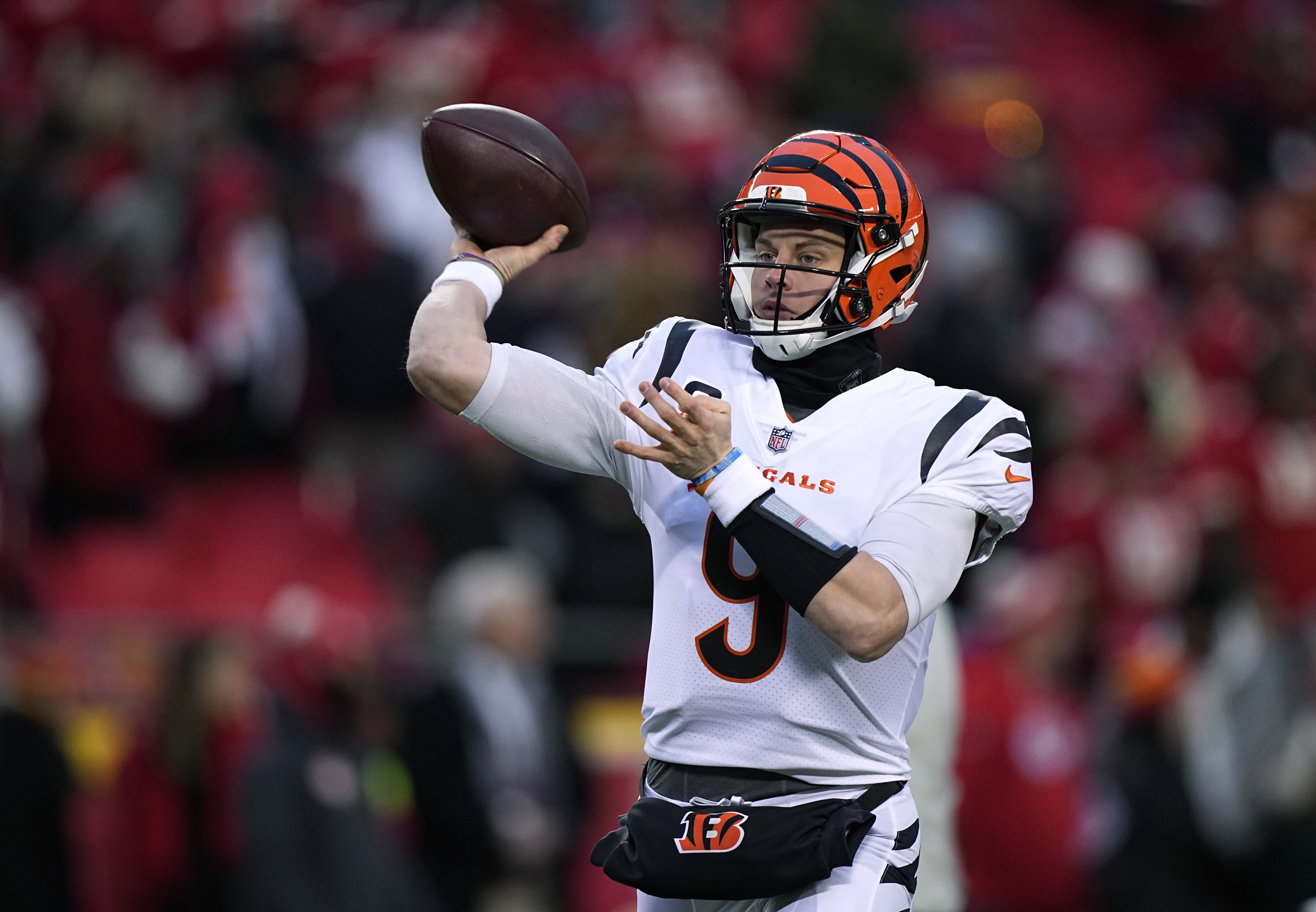 FILE - Cincinnati Bengals quarterback Joe Burrow throws a pass against the Kansas City Chiefs during the first half of the AFC championship NFL football game Jan. 29, 2023, in Kansas City, Mo. The Bengals exercised the fifth-year contract option on Burrow as they move toward signing him to a long-term deal. The Bengals said they made the “mechanical step" Tuesday, April 25, as they work with Burrow and his representatives toward securing him for the future. (AP Photo/Brynn Anderson, File)