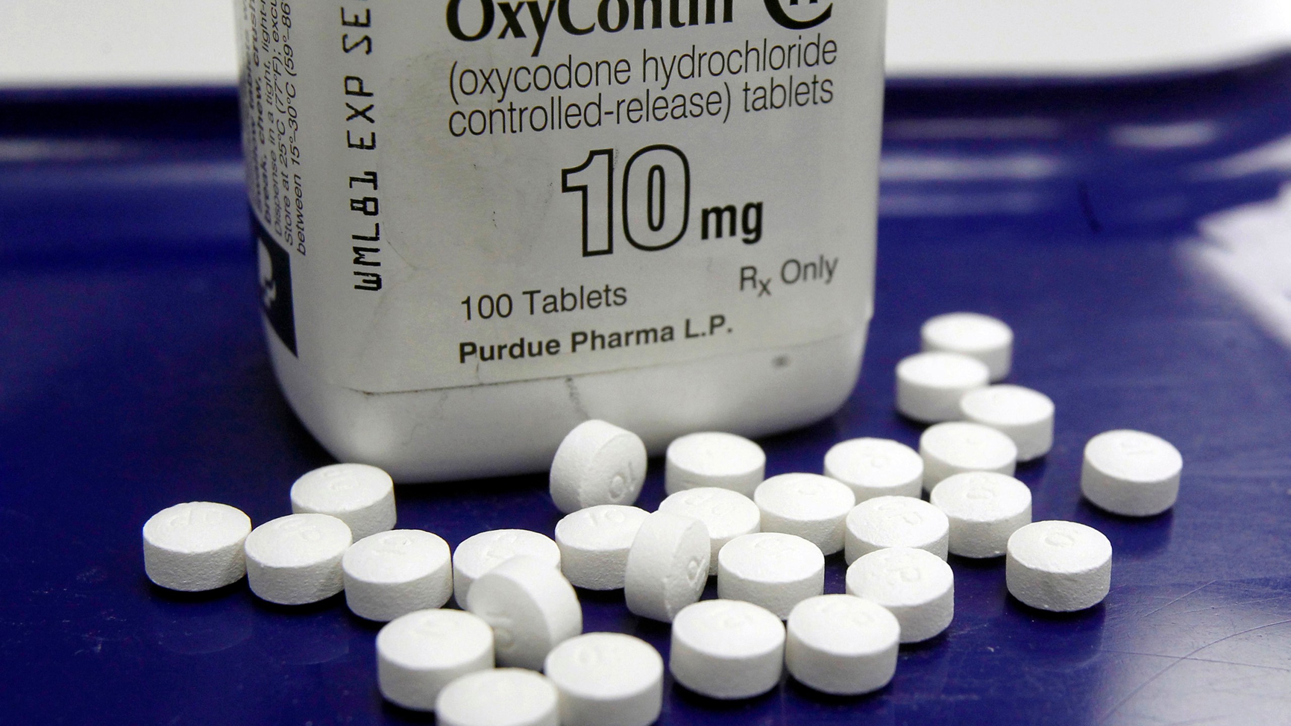 FILE - OxyContin pills are arranged for a photo at a pharmacy in Montpelier, Vt., Feb. 19, 2013. Purdue and state, local and Native American tribal governments across the U.S. agreed to settle lawsuits over the toll of opioids more than a year ago, but the money isn't flowing yet because of a wait for a key court ruling.(AP Photo/Toby Talbot, File)