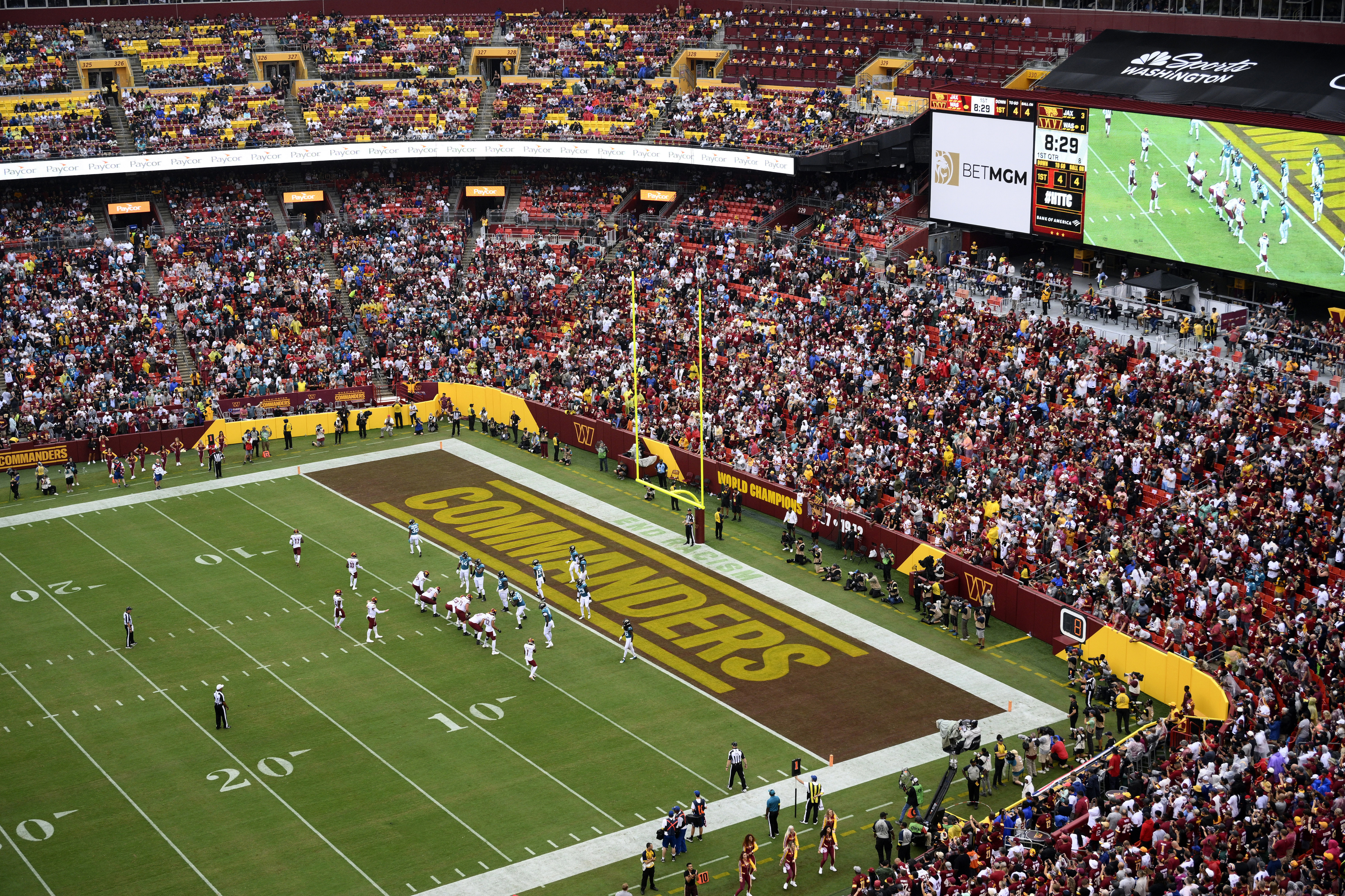 FILE - Fans watch as the Washington Commanders face the Jacksonville Jaguars in an NFL football game, Sunday, Sept. 11, 2022, in Landover, Md. A group led by Josh Harris and Mitchell Rales that includes Magic Johnson has an agreement in principle to buy the NFL's Washington Commanders from longtime owner Dan Snyder for a North American professional sports team record $6 billion, according to a person with knowledge of the situation. The person spoke to The Associated Press on condition of anonymity Thursday, April 13, 2023, because the deal had not been announced. (AP Photo/Nick Wass, File)