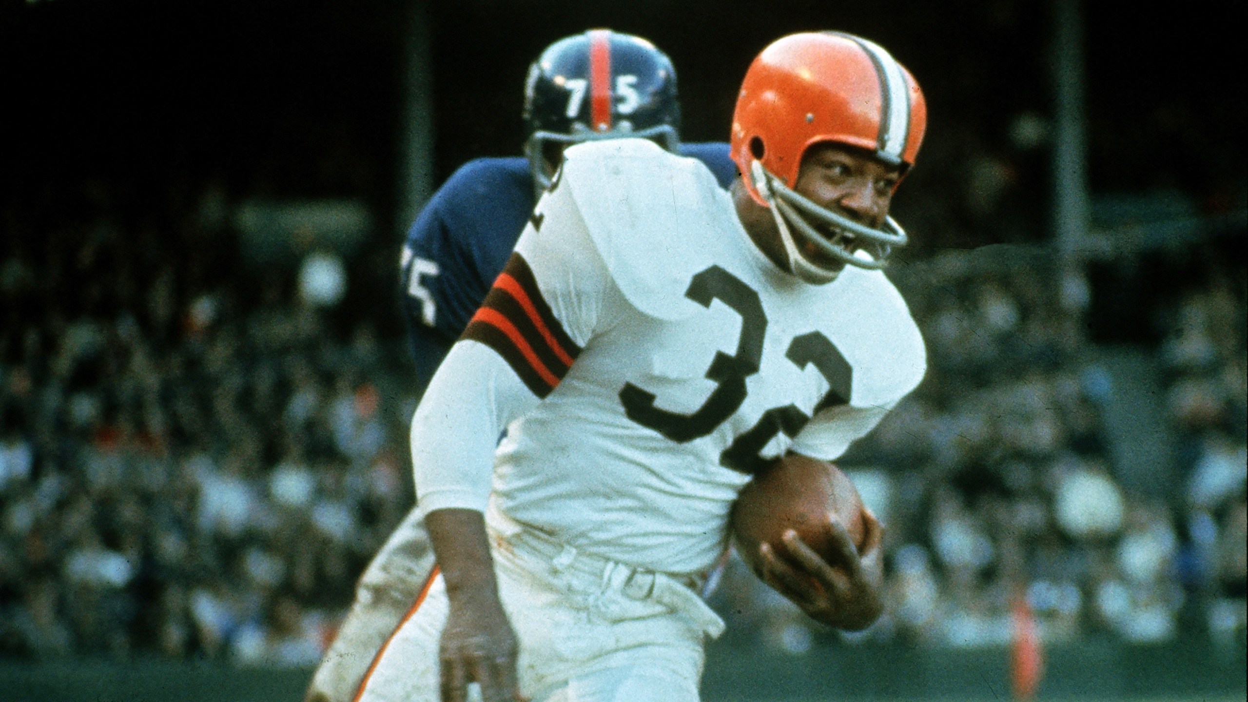 FILE - Jimmy Brown (32), running back for the Cleveland Browns, is shown in action against the New York Giants in Cleveland, Ohio, on Nov. 14, 1965. NFL legend, actor and social activist Jim Brown passed away peacefully in his Los Angeles home on Thursday night, May 18, 2023, with his wife, Monique, by his side, according to a spokeswoman for Brown's family. He was 87. (AP Photo/File)