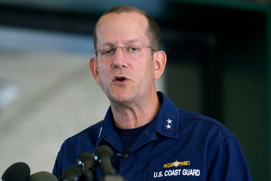 U.S. Coast Guard Rear Adm. John Mauger, commander of the First Coast Guard District, speaks to the media, Monday, June 19, 2023, in Boston. A search is underway for a missing submersible that carries people to view the wreckage of the Titanic. Canadian officials say the five-person submersible was reported overdue Sunday night about 435 miles (700 kilometers) south of St. John's, Newfoundland and that the search is being led by the U.S. Coast Guard. (AP Photo/Steven Senne)