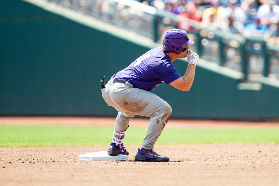 TCU base runner Kurtis Byrne (4) celebrates a double in the second inning against Oral Roberts in a baseball game at the NCAA College World Series in Omaha, Neb., Tuesday, June 20, 2023. (AP Photo/John Peterson)