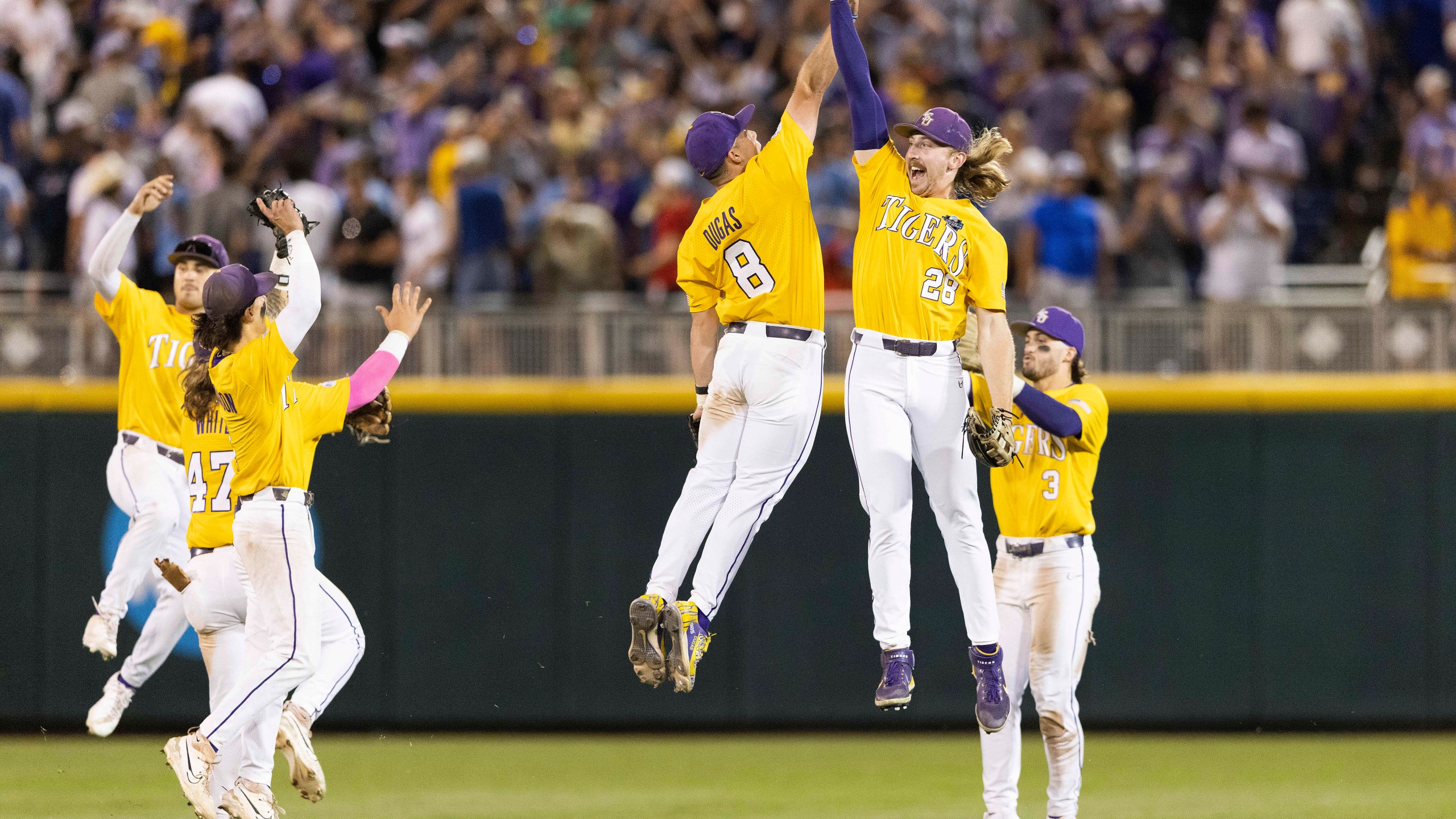 LSU's Gavin Dugas (8) and Paxton Kling (28) celebrate after their win over Florida in 11 innings in Game 1 of the NCAA College World Series baseball finals in Omaha, Neb., Saturday, June 24, 2023. (AP Photo/Rebecca S. Gratz)