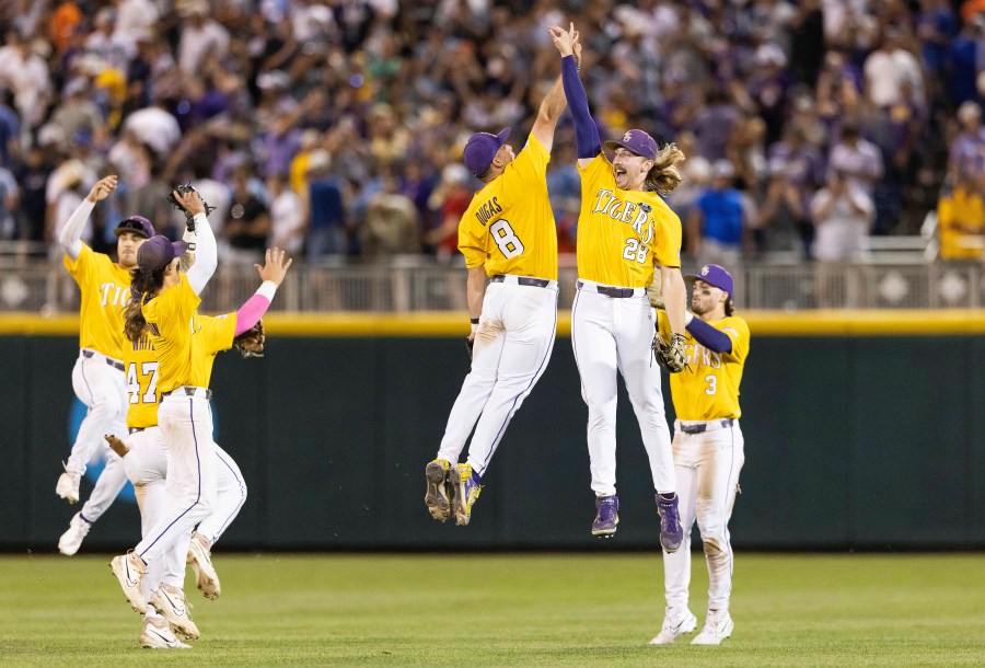 LSU's Gavin Dugas (8) and Paxton Kling (28) celebrate after their win over Florida in 11 innings in Game 1 of the NCAA College World Series baseball finals in Omaha, Neb., Saturday, June 24, 2023. (AP Photo/Rebecca S. Gratz)