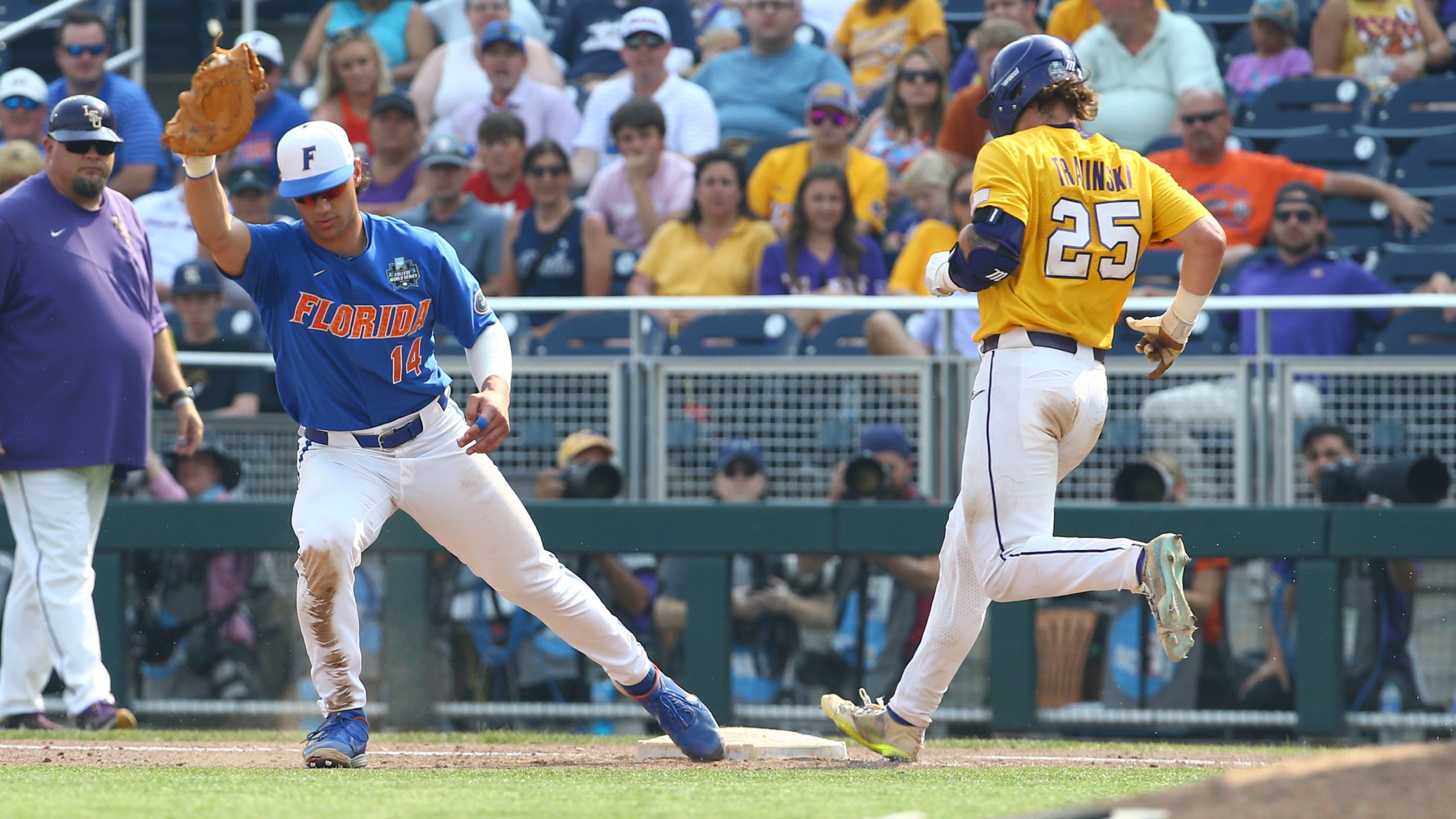 LSU's Hayden Travinski (25) is forced out as Florida first baseman Jac Caglianone (14) covers the bag during the eighth inning of Game 2 of the NCAA College World Series baseball finals in Omaha, Neb., Sunday, June 25, 2023. (AP Photo/John Peterson)