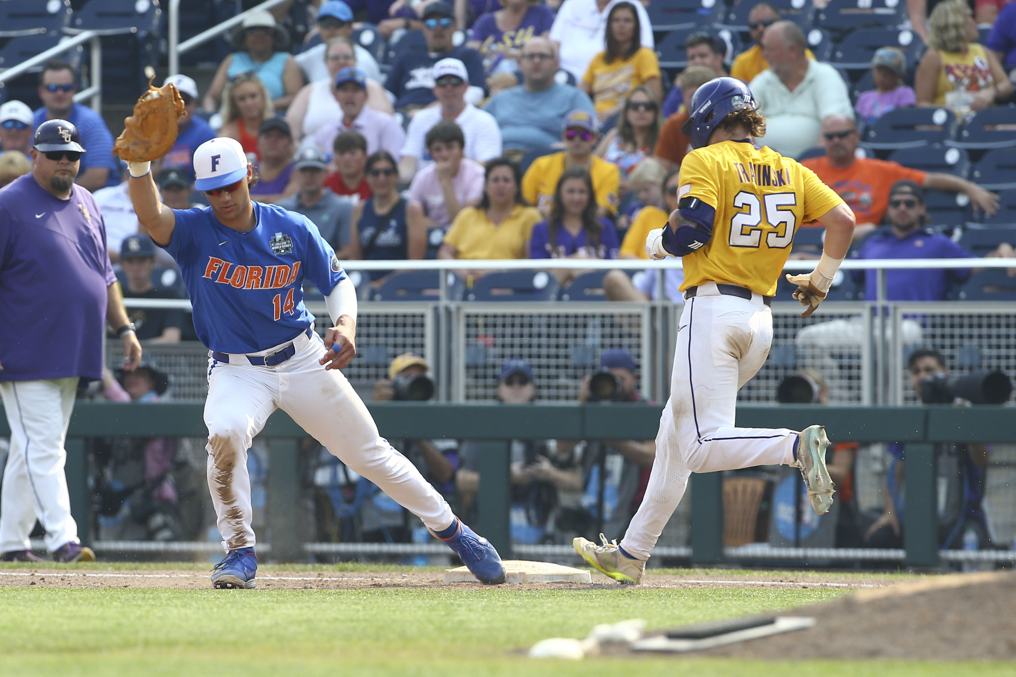 LSU's Hayden Travinski (25) is forced out as Florida first baseman Jac Caglianone (14) covers the bag during the eighth inning of Game 2 of the NCAA College World Series baseball finals in Omaha, Neb., Sunday, June 25, 2023. (AP Photo/John Peterson)