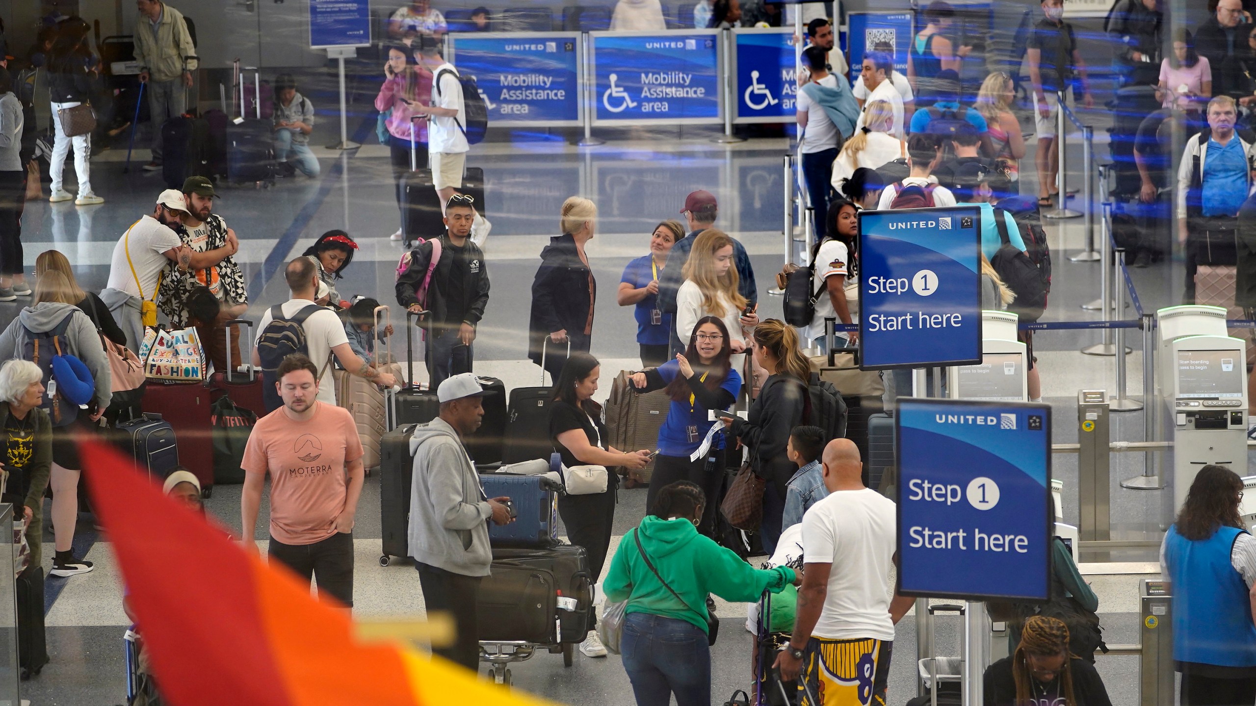 Travelers line up at the departure area check-in at the United Airlines terminal at Los Angeles International airport, Wednesday June 28, 2023, in Los Angeles. Travelers waited out widespread delays at U.S. airports on Tuesday, an ominous sign heading into the long July 4 holiday weekend, which is shaping up as the biggest test yet for airlines that are struggling to keep up with surging numbers of passengers. (AP Photo/Damian Dovarganes)