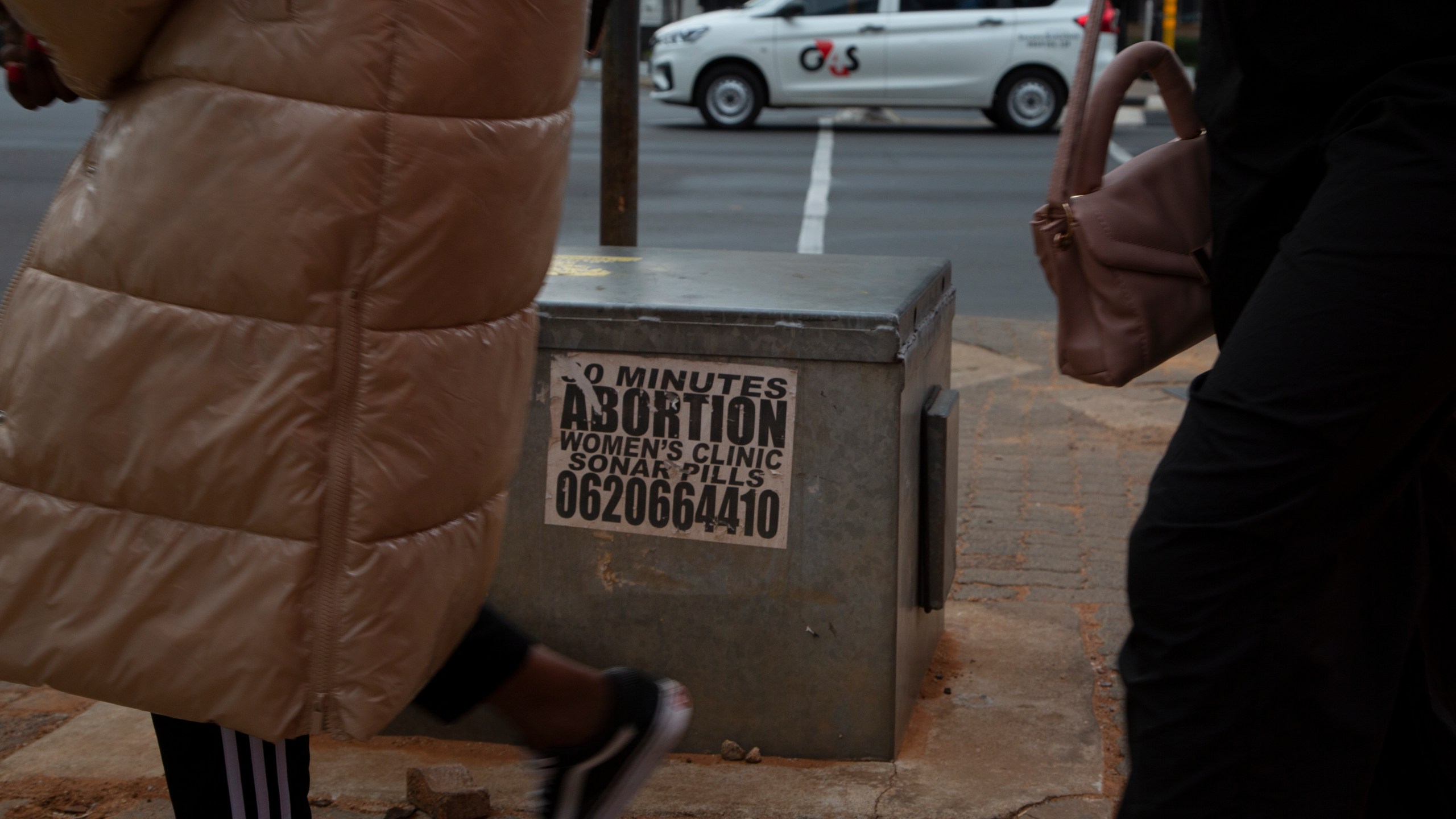 Women pass a sticker advertising abortion pills on a sidewalk in Johannesburg, Wednesday June 28, 2023. When the U.S. Supreme Court overturned the national right to an abortion a year ago, it shook efforts to legalize and make abortions safer in Africa. Sub-Saharan Africa has the world's highest rate of unintended pregnancies, and 77% of abortions are estimated to be unsafe. (AP Photo/Denis Farrell)