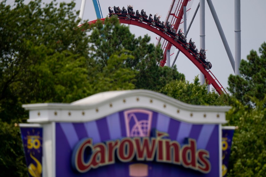 People ride a roller coaster at the Carowinds amusement park on Monday, July 3, 2023, in Charlotte, N.C. (AP Photo/Erik Verduzco)