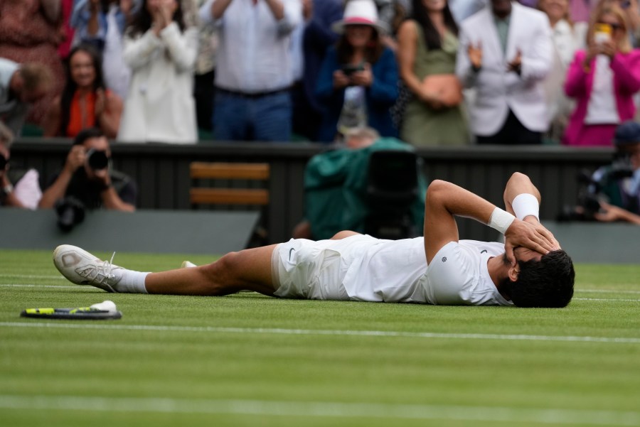 Spain's Carlos Alcaraz celebrates after beating Serbia's Novak Djokovic to win the final of the men's singles on day fourteen of the Wimbledon tennis championships in London, Sunday, July 16, 2023. (AP Photo/Kirsty Wigglesworth)