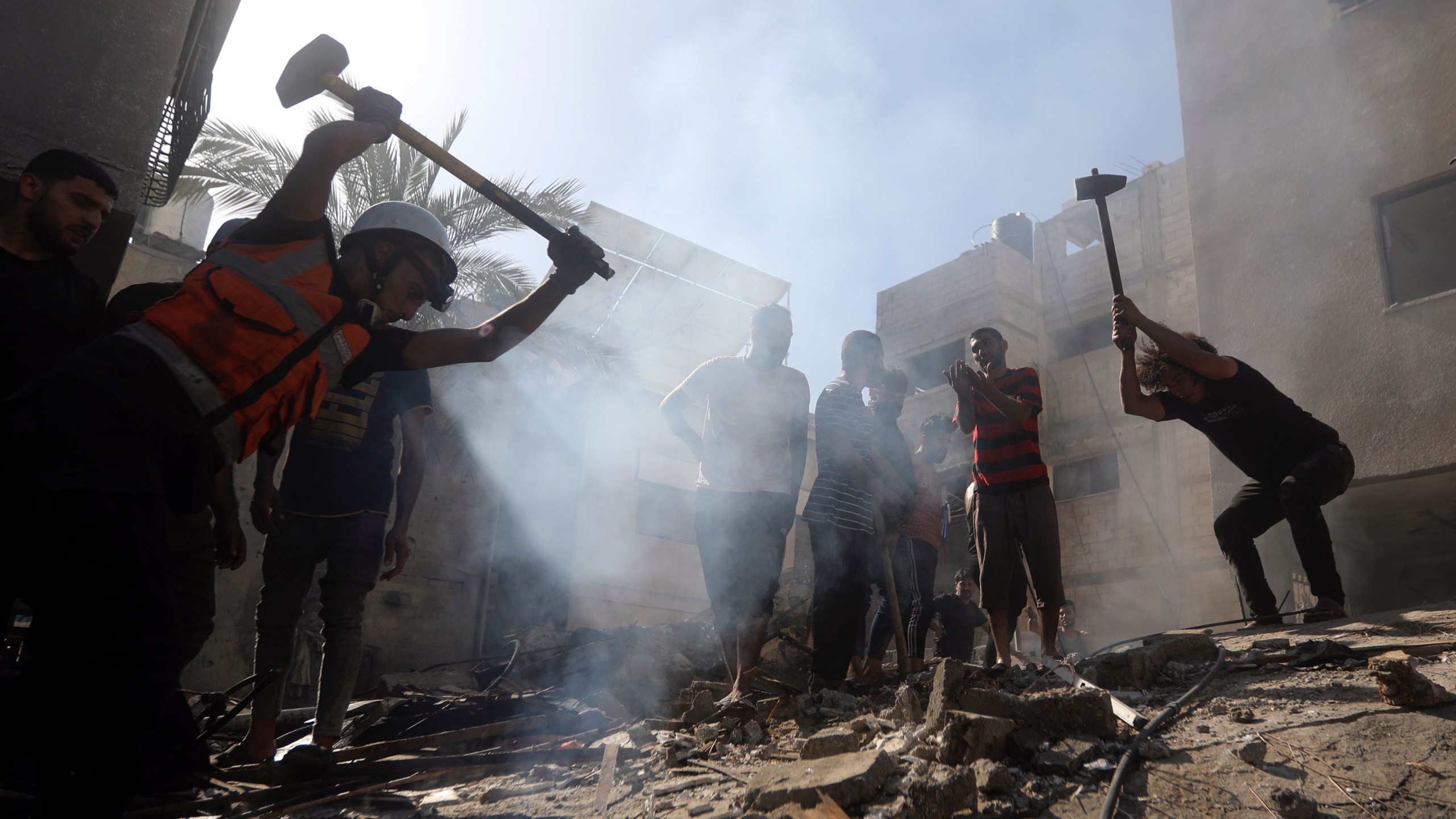 Palestinians look for survivors under the rubble of a destroyed building following an Israeli airstrike in Khan Younis refugee camp, southern Gaza Strip, Monday, Nov. 6, 2023. (AP Photo/Mohammed Dahman)