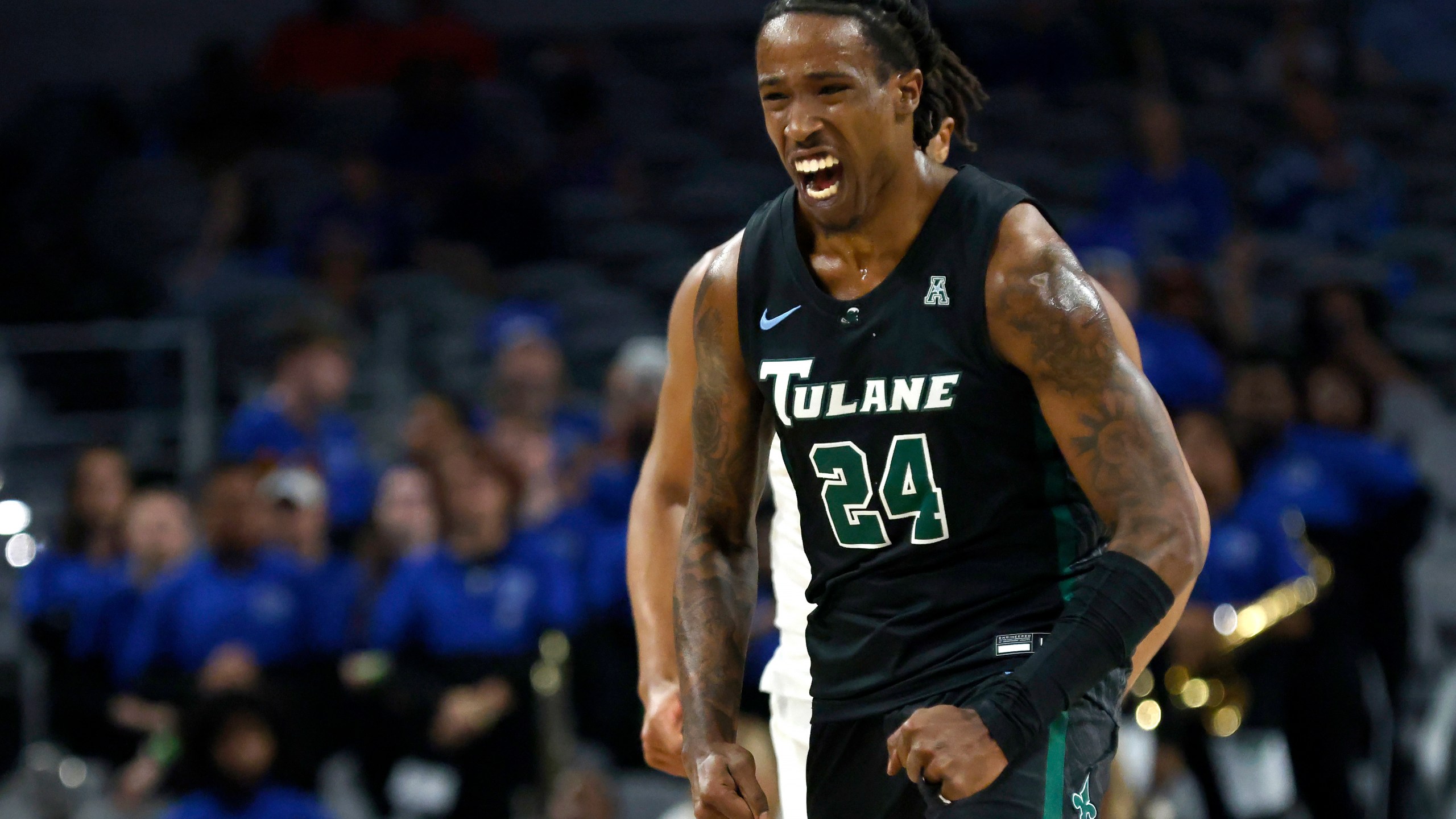 FILE - Tulane forward Kevin Cross (24) reacts after scoring a 3-point basket against Memphis during first half of an NCAA college basketball game in the semifinals of the American Athletic Conference Tournament, Saturday, March 11, 2023, in Fort Worth, Texas. Cross of Tulane is The Associated Press national player of the week after having consecutive triple-doubles against Furman and Southern last week. (AP Photo/Ron Jenkins, File)