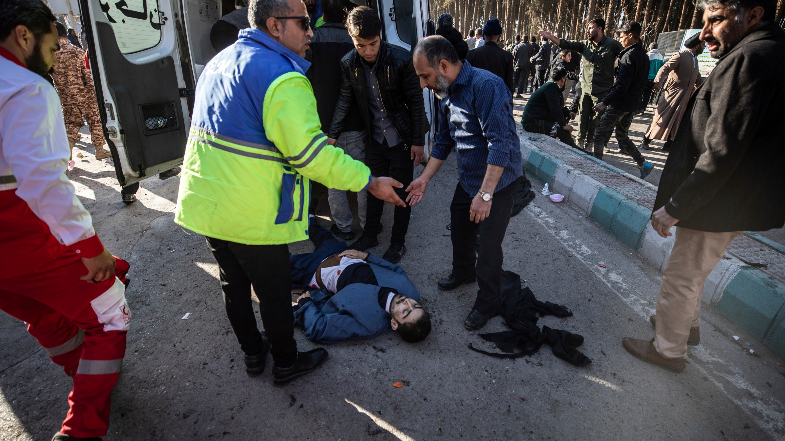 An injured man gets aid after an explosion in Kerman, Iran, Wednesday, Jan. 3, 2024. Iran says the deadly twin bomb blasts occurred at an event honoring a prominent Iranian general slain in a U.S. airstrike in 2020. (Mahdi Karbakhsh Ravari/Mehr News Agnecy via AP)