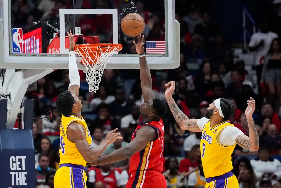 New Orleans Pelicans forward Zion Williamson (1) goes to the basket between Los Angeles Lakers forward Rui Hachimura and forward Anthony Davis (3) in the first half of an NBA basketball play-in tournament game Tuesday, April 16, 2024, in New Orleans. (AP Photo/Gerald Herbert)