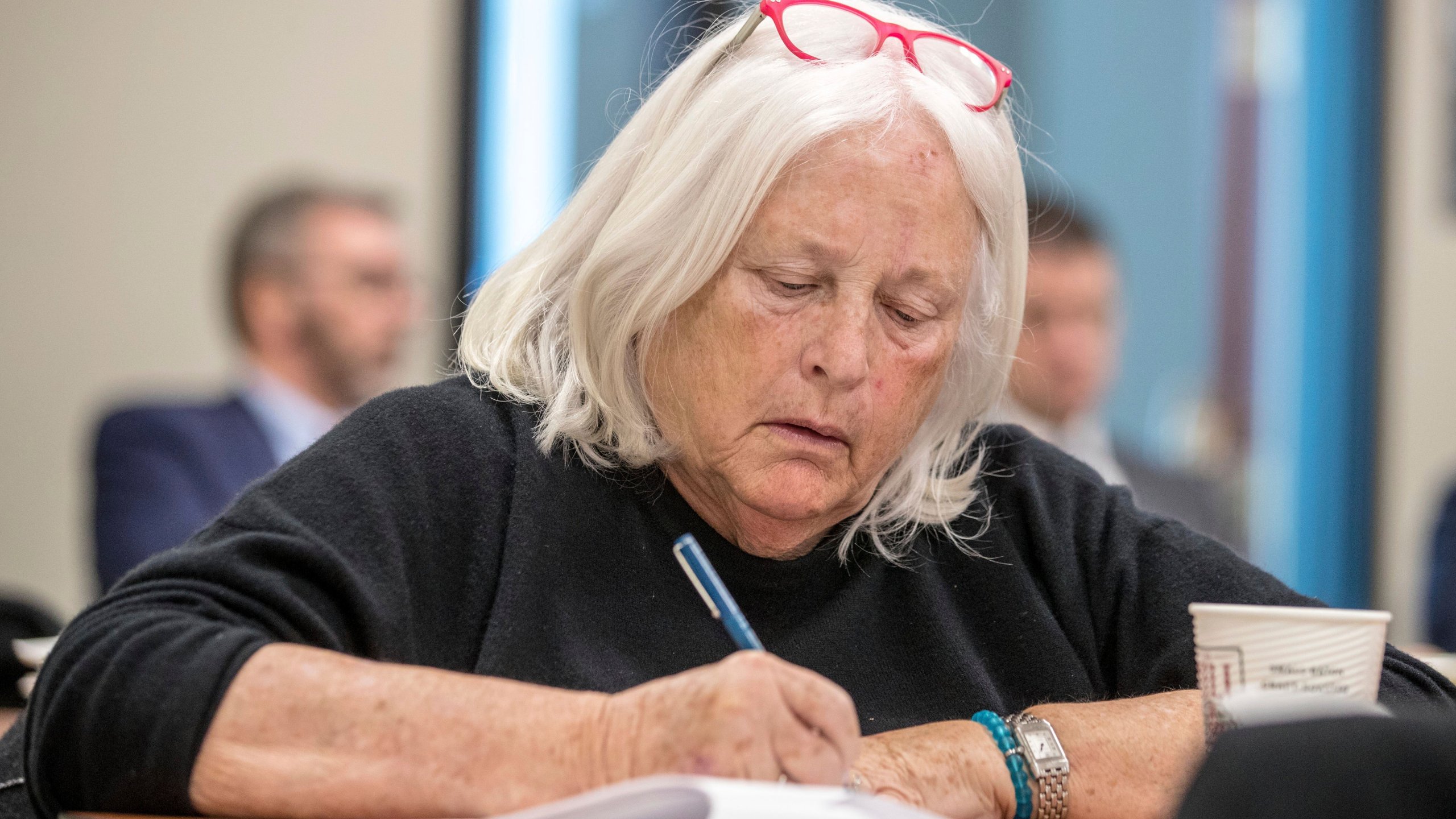 University of Nebraska Board of Regents member Barbara Weitz takes notes while listening to a talk during a tour of the Nebraska Innovation Campus, Thursday, Jan. 24, 2019, in Lincoln, Neb. Nebraska's Memorial Stadium is due for a major renovation, and regent Barbara Weitz of Omaha suggested during a recent board meeting that part of the plan could include building a columbarium under the football field where departed fans would have their ashes inurned. (Chris Machian/Omaha World-Herald via AP)