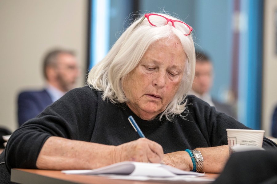 University of Nebraska Board of Regents member Barbara Weitz takes notes while listening to a talk during a tour of the Nebraska Innovation Campus, Thursday, Jan. 24, 2019, in Lincoln, Neb. Nebraska's Memorial Stadium is due for a major renovation, and regent Barbara Weitz of Omaha suggested during a recent board meeting that part of the plan could include building a columbarium under the football field where departed fans would have their ashes inurned. (Chris Machian/Omaha World-Herald via AP)