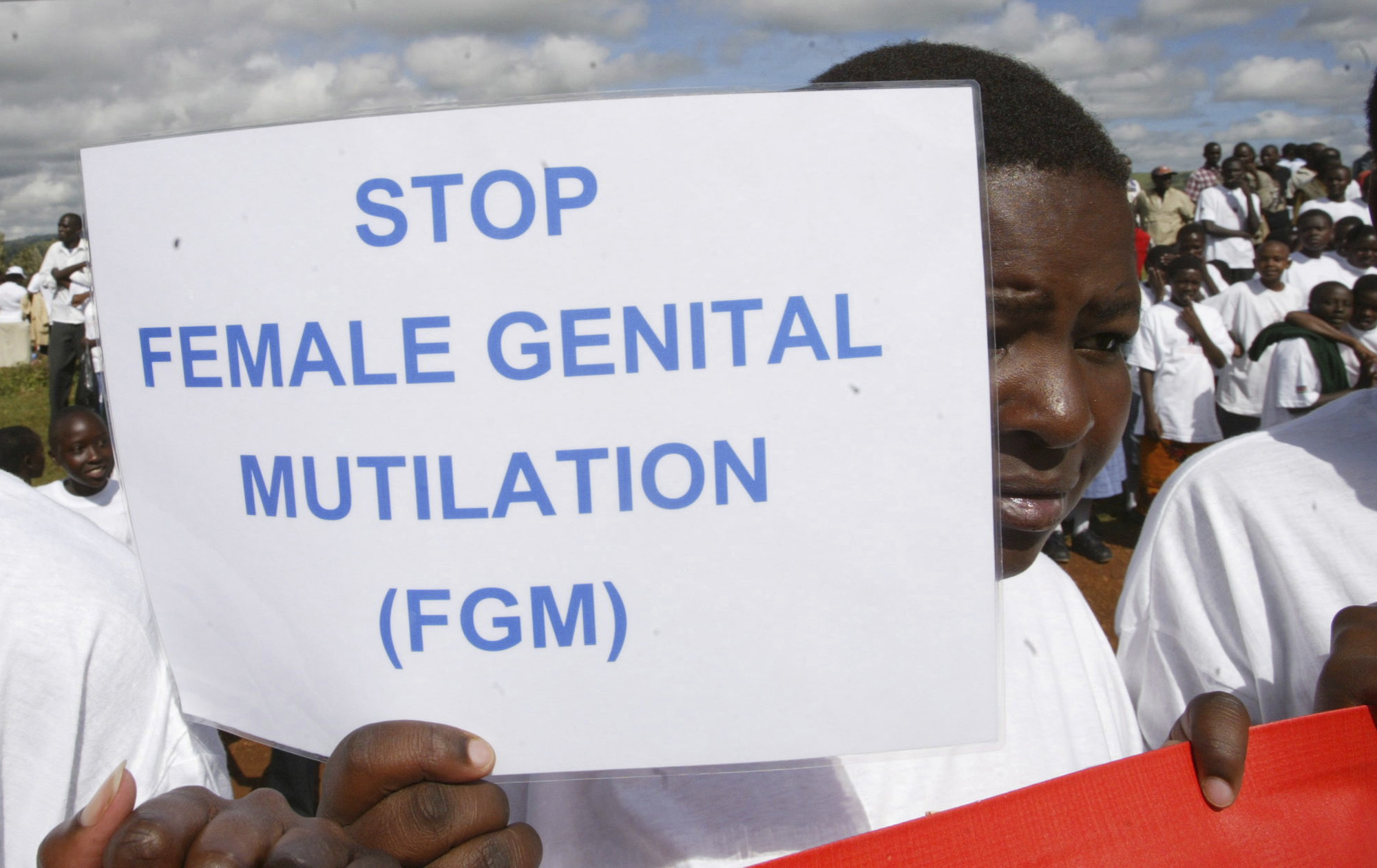 FILE - A Masai girl holds a protest sign during the anti-Female Genital Mutilation (FGM) run in Kilgoris, Kenya, on April 21, 2007. Lawmakers in the West African nation of Gambia on Monday July 15, 2024 rejected a bill that would have overturned a ban on female genital cutting. The attempt to become the first country in the world to reverse such a ban had been closely followed by activists abroad. (AP Photo/Sayyid Azim, File)