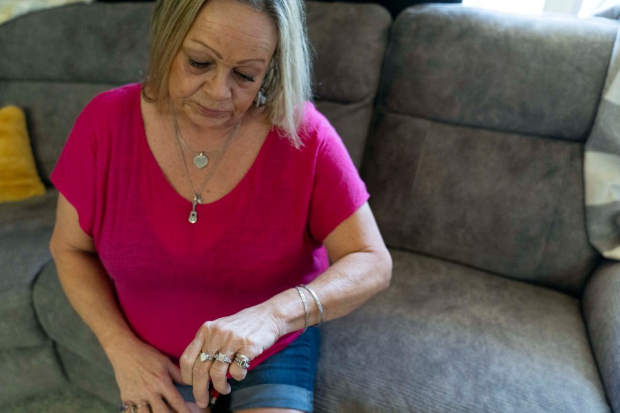 Lori Ellinger wears a heart-shaped ring that holds the ashes of her late son, Trea Ellinger, Monday, July 1, 2024, in her home in Glen Burnie, Md. (AP Photo/Stephanie Scarbrough)