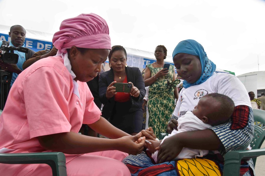 A health worker administers the malaria vaccine Oxford-Serum R21 to a child in Abidjan, Ivory Coast, Monday, July 15, 2024. (AP Photo/Diomande Ble Blonde)