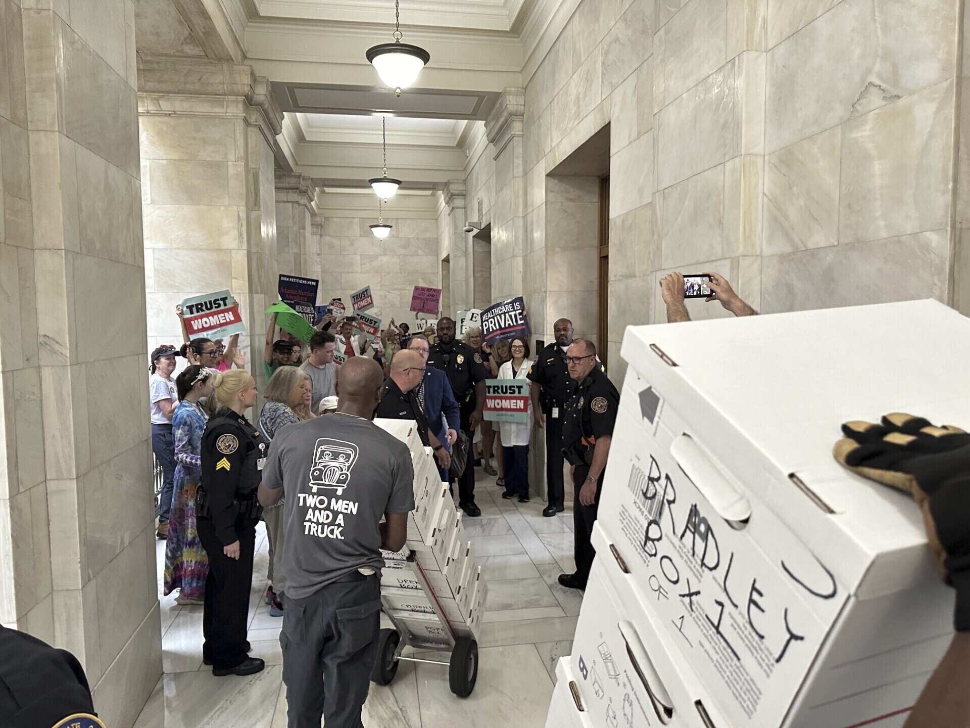 FILE - Boxes containing signatures supporting a proposed ballot measure to scale back Arkansas' abortion ban are delivered to a room in the state Capitol, Friday, July 5, 2024, in Little Rock, Ark. Supporters of a proposal to ask voters to scale back Arkansas’ abortion ban sued the state on Tuesday, July 16, for rejecting their petitions to get the measure on the November ballot. (AP Photo/Andrew DeMillo, File)