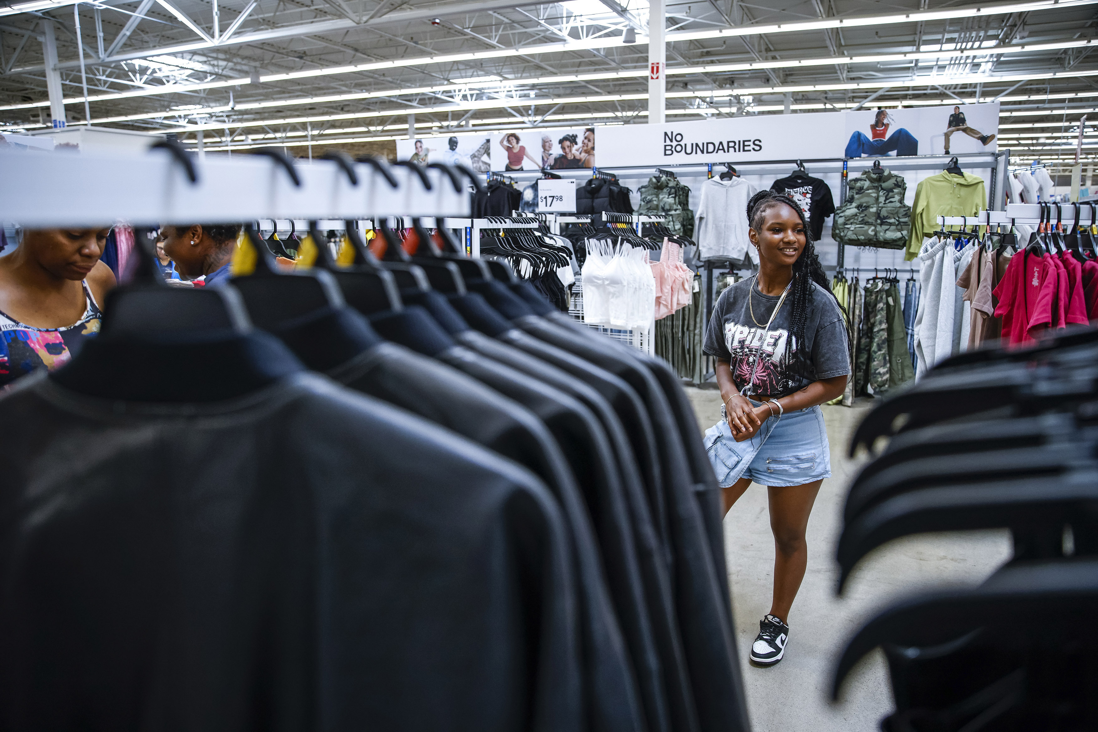 Za'kyra Davis checks out clothes from Walmart's No Boundaries collection at a Walmart Superstore in Secaucus, New Jersey, Thursday, July 11, 2024. Davis, who shops at chains like Rue21 and Forever 21 and gets inspired by fashion trends she sees on social media, said she has been more open to buying clothes at Walmart in the past few months. (AP Photo/Eduardo Munoz Alvarez)