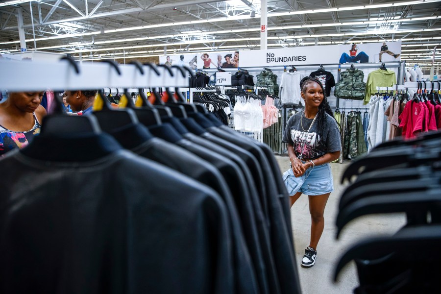 Za'kyra Davis checks out clothes from Walmart's No Boundaries collection at a Walmart Superstore in Secaucus, New Jersey, Thursday, July 11, 2024. Davis, who shops at chains like Rue21 and Forever 21 and gets inspired by fashion trends she sees on social media, said she has been more open to buying clothes at Walmart in the past few months. (AP Photo/Eduardo Munoz Alvarez)