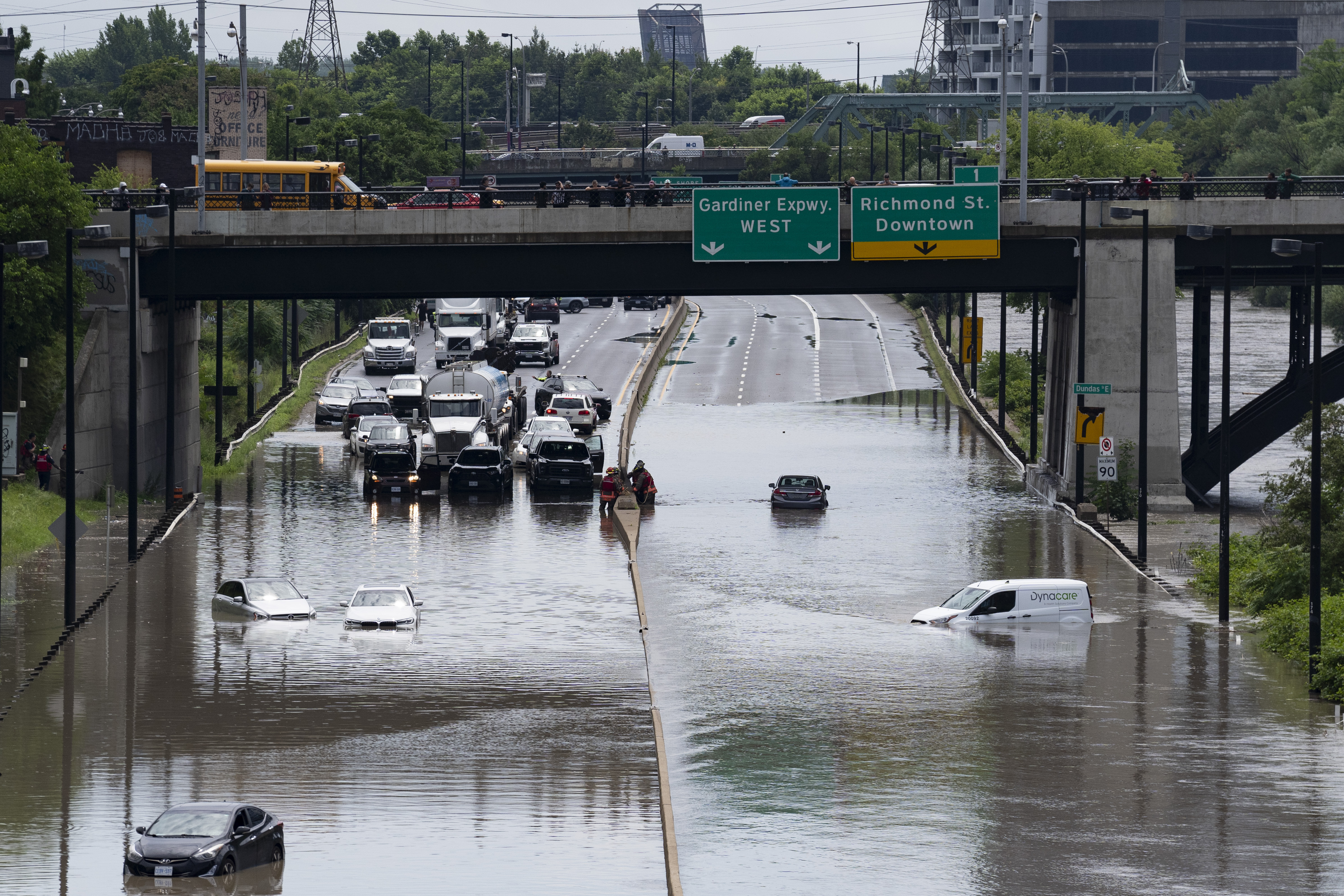 Cars are partially submerged in flood waters in the Don Valley following heavy rain in Toronto, on Tuesday, July 16 2024. (Arlyn McAdorey/The Canadian Press via AP)