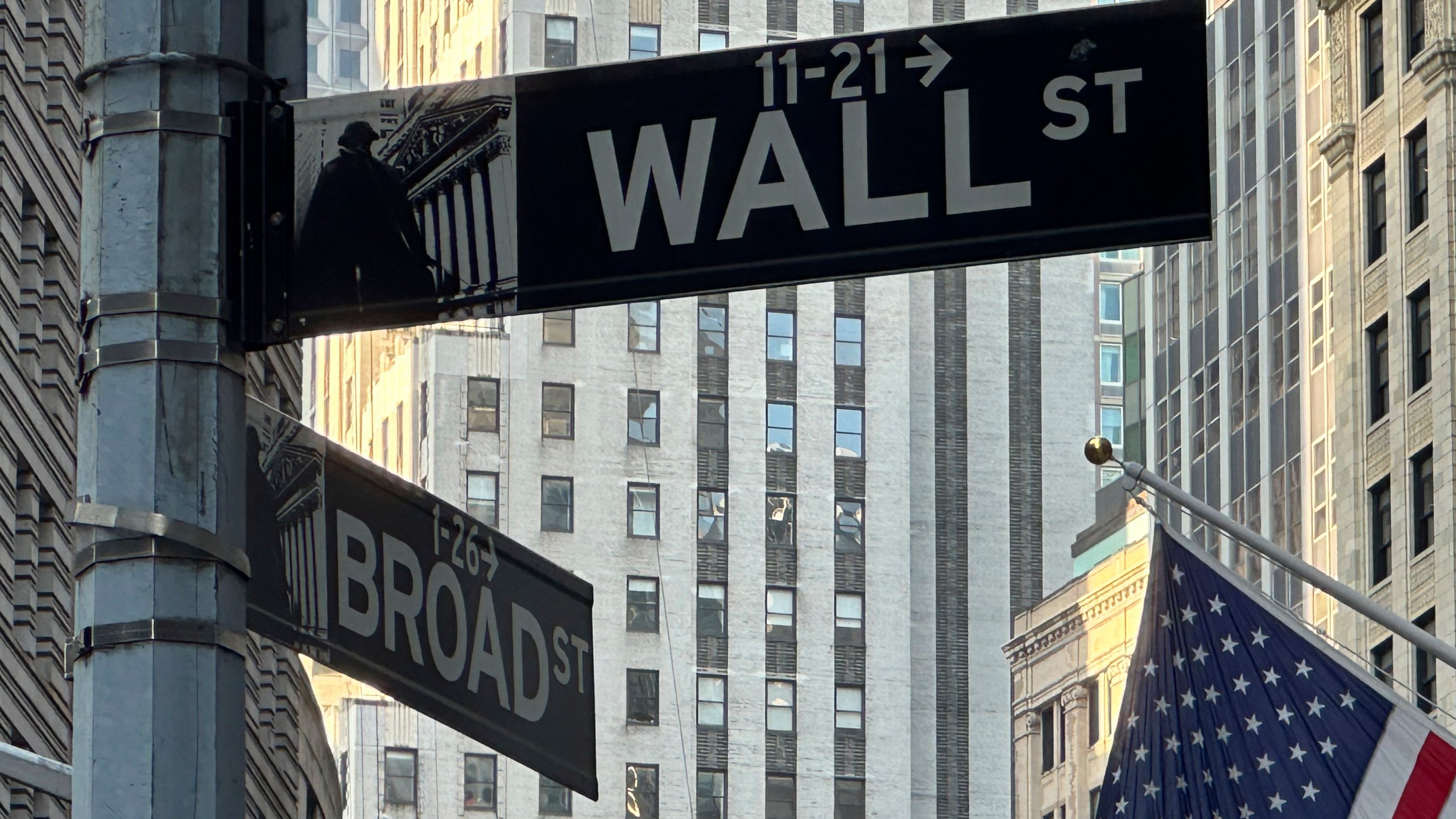 A sign at the intersection of Broad Street and Wall Street is shown on Tuesday, July 16, 2024, in New York. Wall Street is logging tiny gains early as earnings season revs up ahead of the release of U.S. retail sales data that could influence a decision by the Federal Reserve on interest rates. (AP Photo/Peter Morgan)