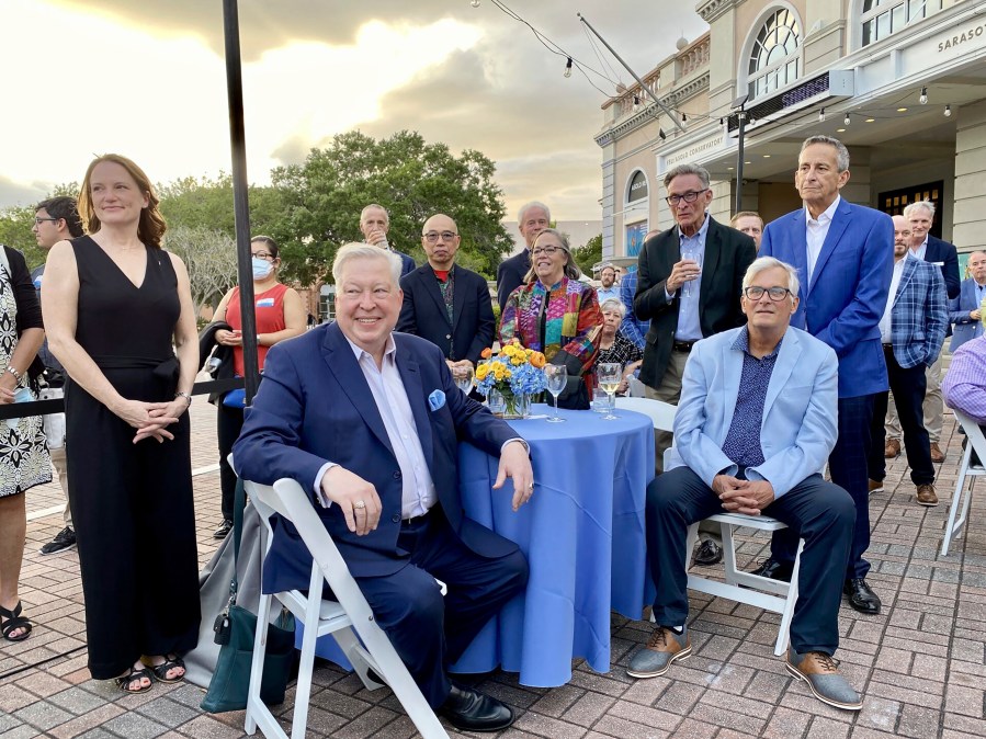 This image provided by Cynthia Moxley shows lottery winner Roy Cockrum (seated, front) at the 2022 opening night of “Knoxville” in Sarasota, Fla, surrounded by friends and board members of the Roy Cockrum Foundation. The foundation was the play’s major funder. (Cynthia Moxley via AP)