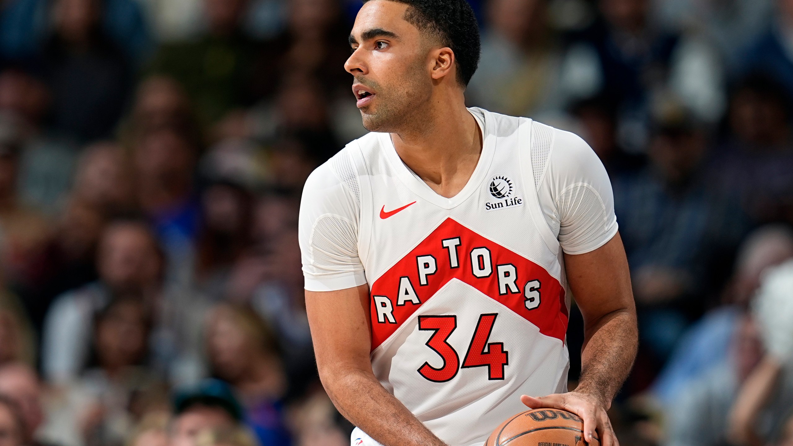 FILE - Toronto Raptors center Jontay Porter (34) looks to pass in the first half of an NBA basketball game Monday, March 11, 2024, in Denver. Court papers indicate that former Toronto Raptors player Jontay Porter will be charged with a federal felony connected to the sports betting scandal that spurred the NBA to ban him for life. (AP Photo/David Zalubowski, File)