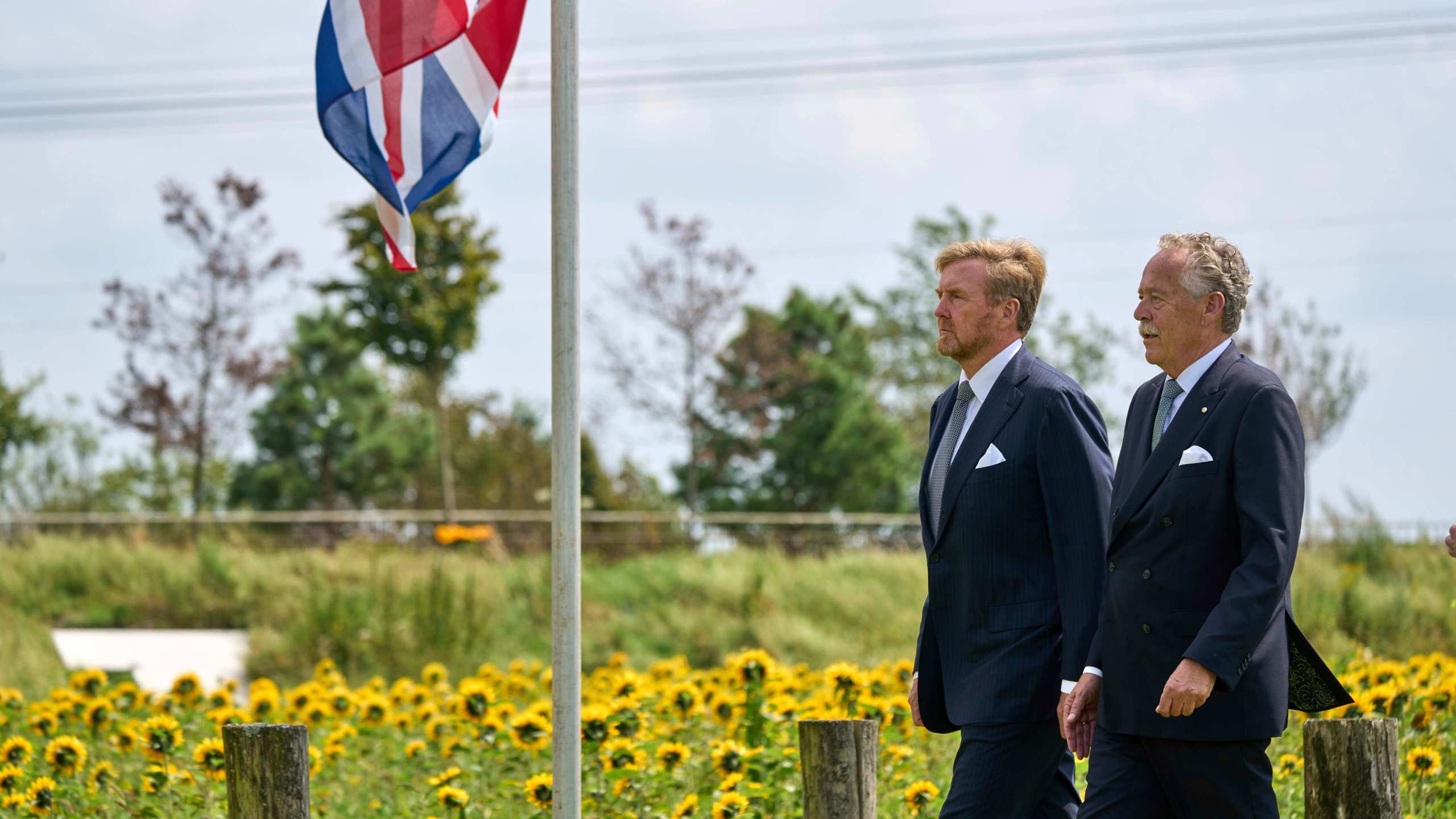 Dutch King Willem Alexander, left, arrives with Piet Ploeg, to attend a commemoration at the national monument in Vijfhuizen, Netherlands, Wednesday July 17, 2024, to mark the tenth anniversary of the downing of flight MH17 in eastern Ukraine, which killed all 298 people on board. (AP Photo/Phil Nijhuis)