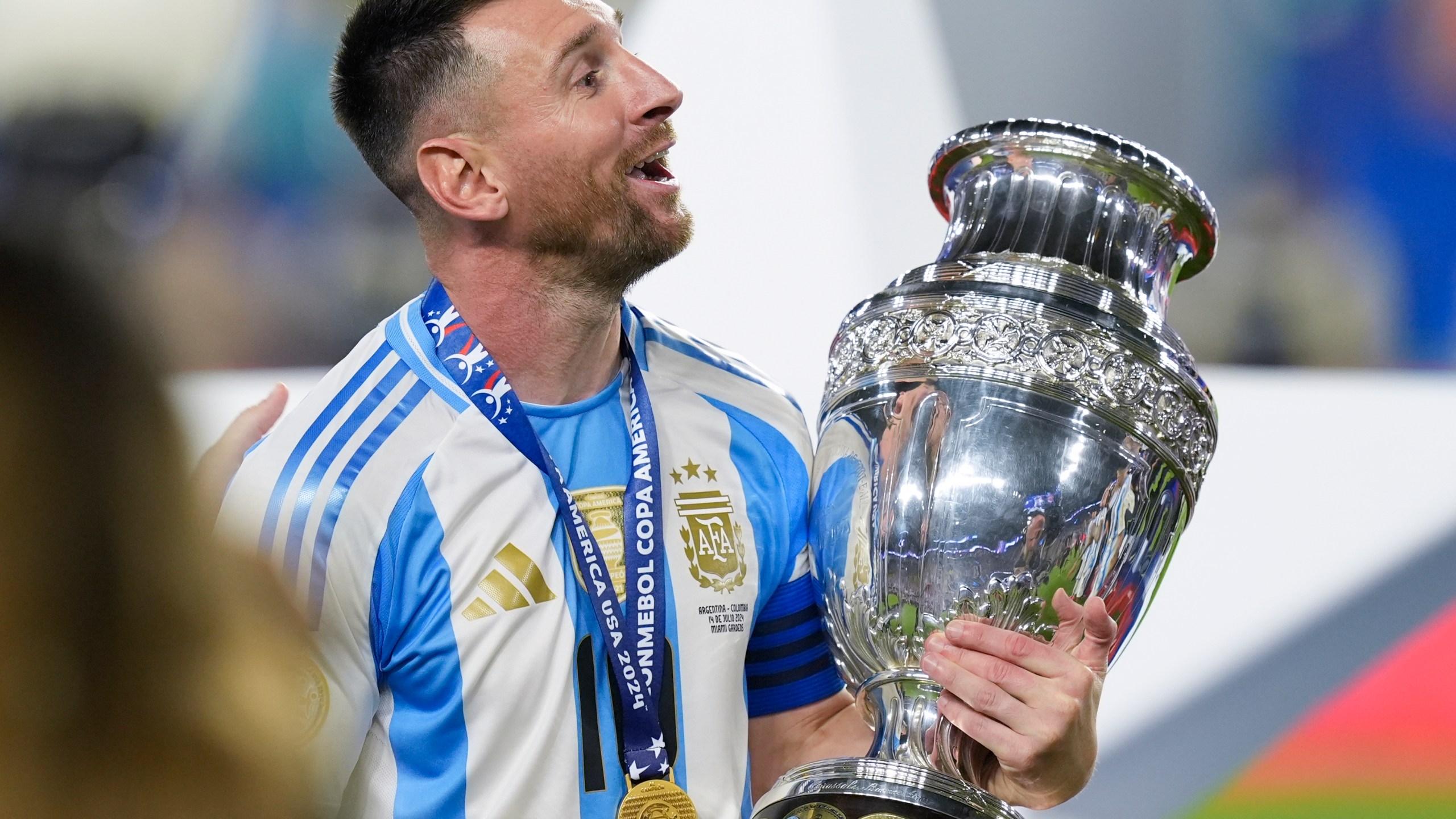 Argentina's Lionel Messi celebrates with the trophy after his team defeated Colombia in the Copa America final soccer match in Miami Gardens, Fla., Monday, July 15, 2024. (AP Photo/Rebecca Blackwell)