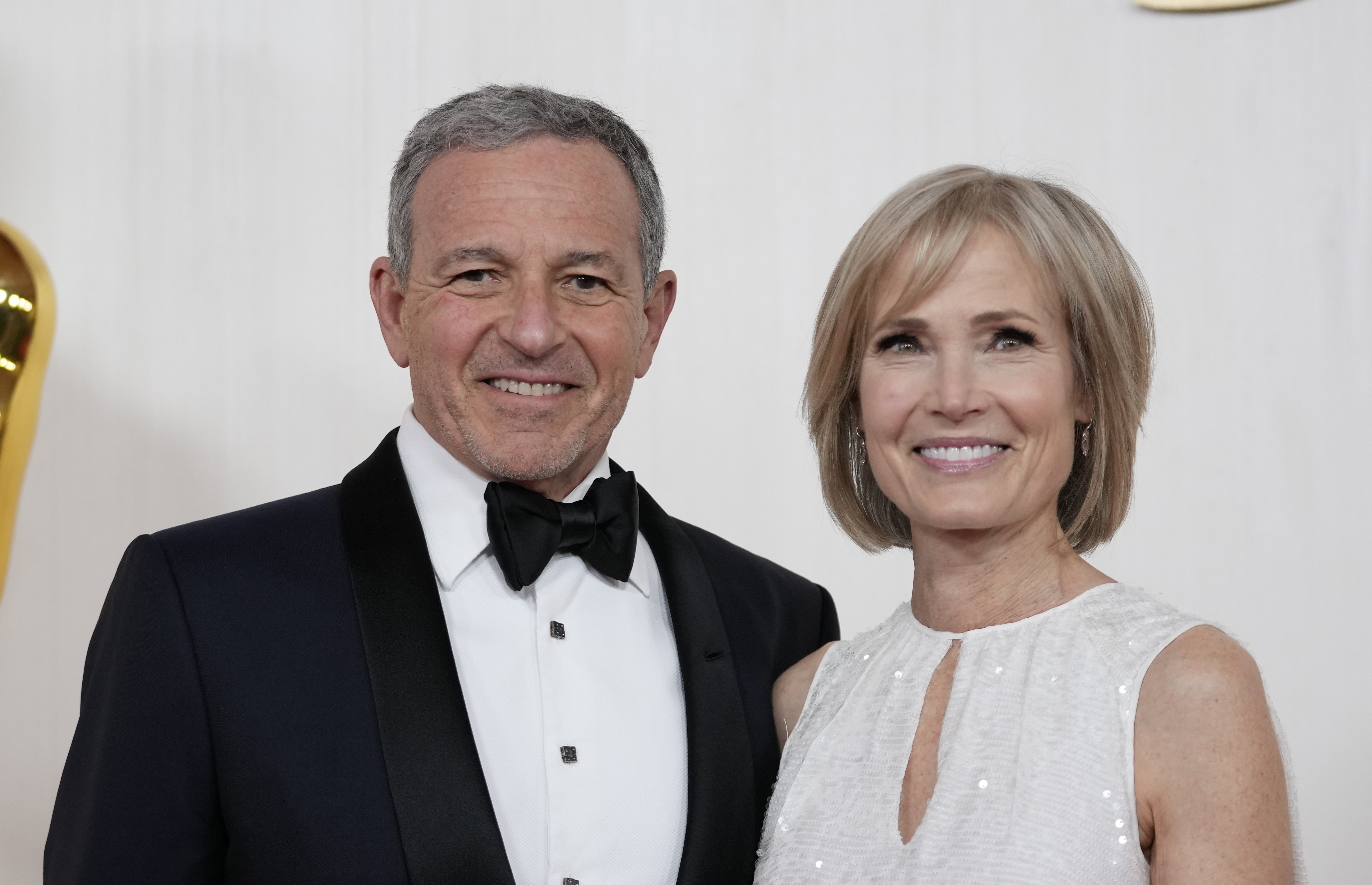 FILE - Bob Iger, left, and Willow Bay arrive at the Oscars on Sunday, March 10, 2024, at the Dolby Theatre in Los Angeles. Angel City FC announced Wednesday, July 17, 2024, that Walt Disney Company CEO Bob Iger and Southern California dean for communication and journalism Willow Bay will be the new controlling owners of what the franchise calls the most valuable women’s sports team in the world. (AP Photo/Ashley Landis, File)