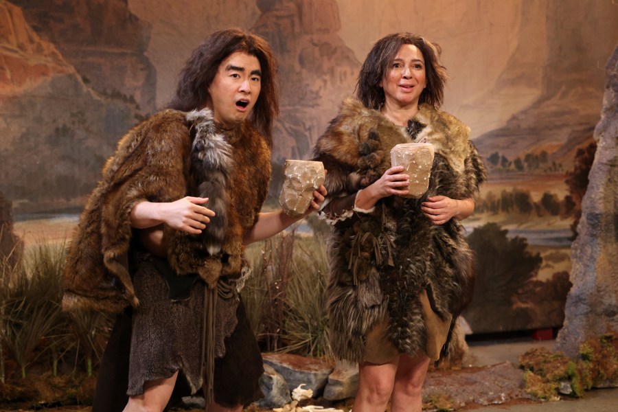 This image released by NBC shows Bowen Yang, left, and host Maya Rudolph during the "British Cavemen" sketch on "Saturday Night Live," in New York on May 11, 2024. (Will Heath/NBC via AP)