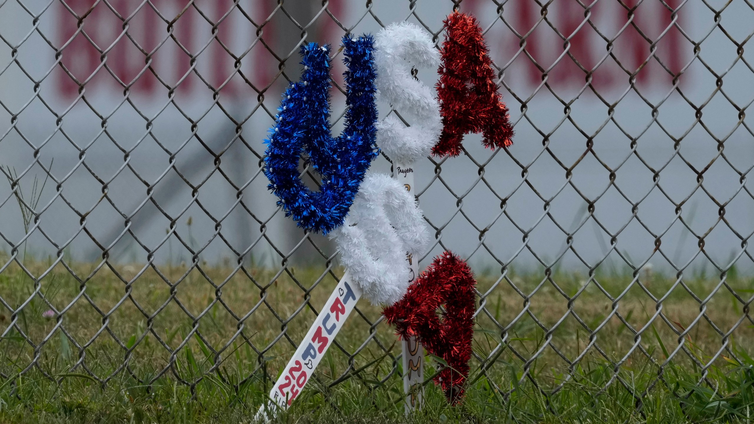 A memorial rest along a fence outside the Butler Farm Show in Butler, Pa., Wednesday, July 17, 2024, the site where firefighter Corey Comperatore died after a gunman opened fire at the rally. (AP Photo/Eric Gay)