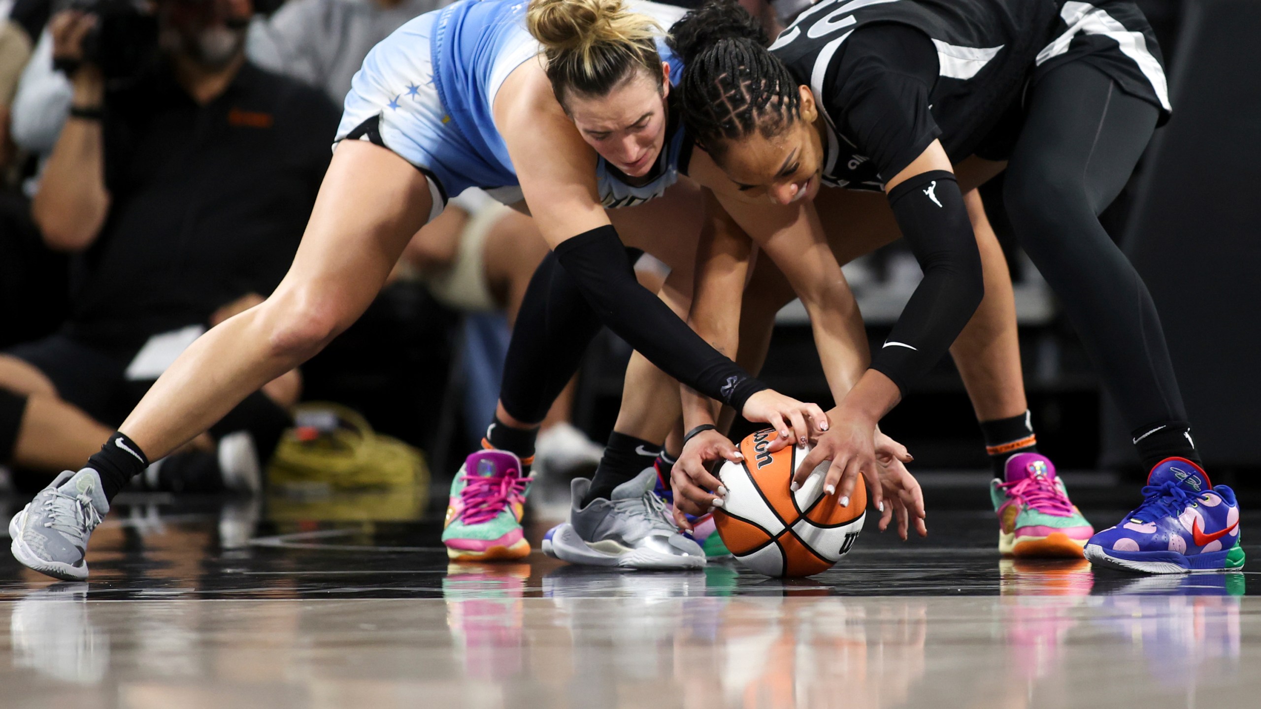 Chicago Sky guard Marina Mabrey, left, and Las Vegas Aces center A'ja Wilson struggle for a loose ball during the second half of a WNBA basketball game, Tuesday, July 16, 2024, in Las Vegas. (Ellen Schmidt/Las Vegas Review-Journal via AP)