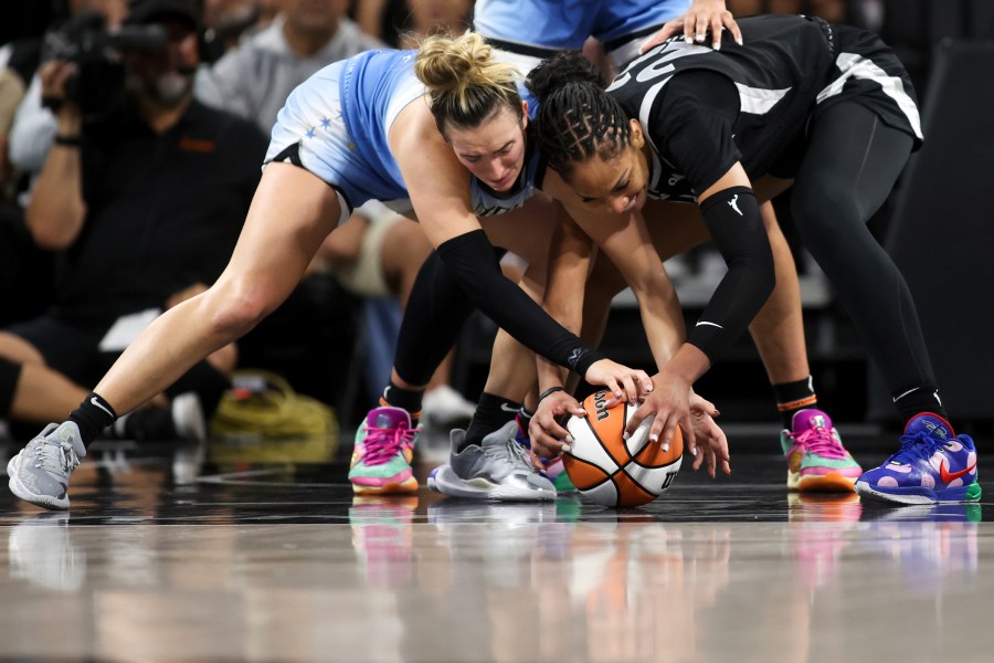 Chicago Sky guard Marina Mabrey, left, and Las Vegas Aces center A'ja Wilson struggle for a loose ball during the second half of a WNBA basketball game, Tuesday, July 16, 2024, in Las Vegas. (Ellen Schmidt/Las Vegas Review-Journal via AP)