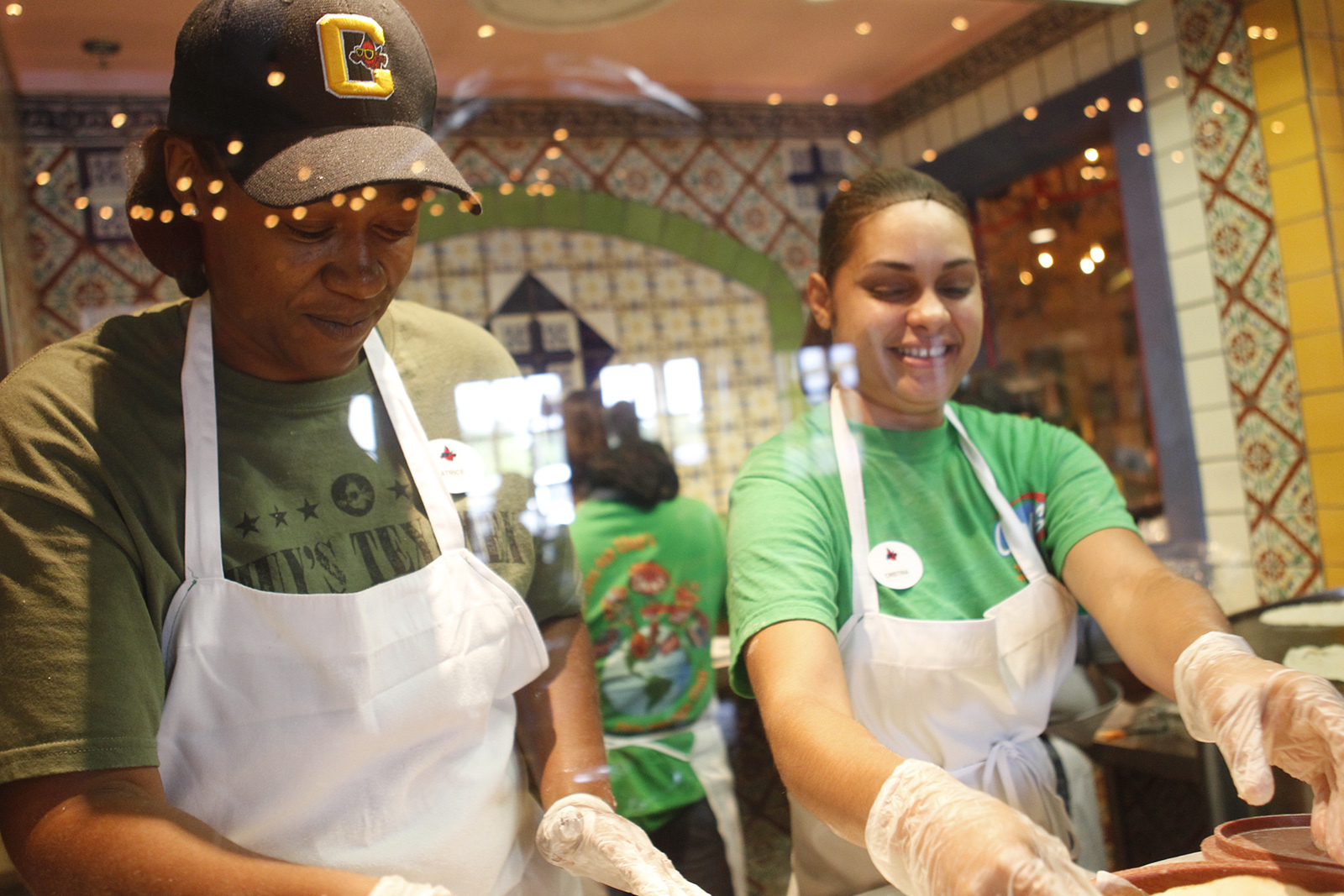 FILE - Latrice Walker and Christina Rivera make fresh tortillas on opening day at Chuy's in Jacksonville, N.C., May 13, 2014. On Wednesday, July 17, 2024, Darden Restaurants announced it's buying Chuy's restaurant chain. (AP Photo/The Daily News, Maria Sestito, File)